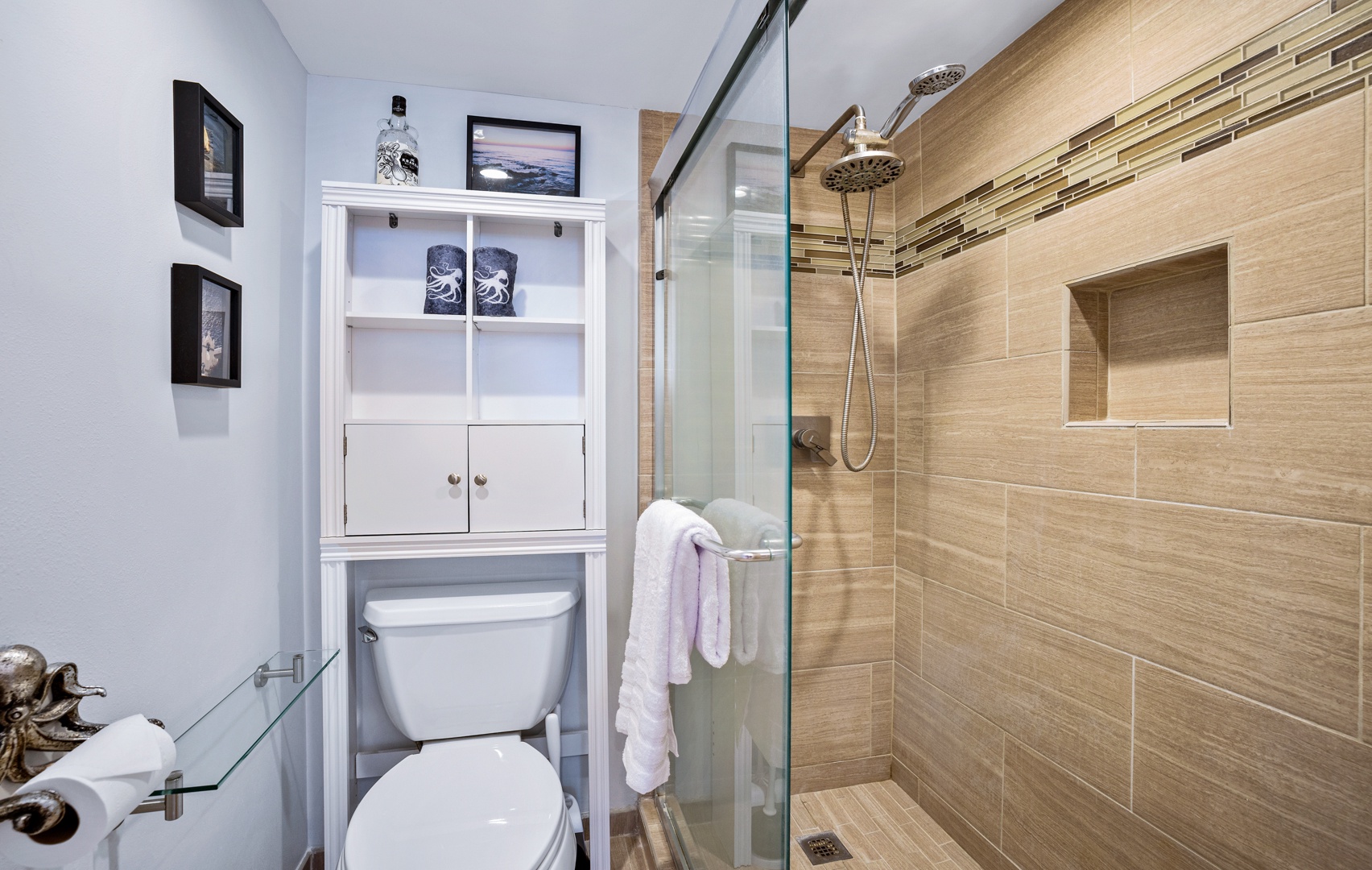 Lahaina Vacation Rentals, Valley Isle 804 - This modern bathroom features a sleek glass shower with contemporary tile work, the additional shelving provides ample storage for all your essentials