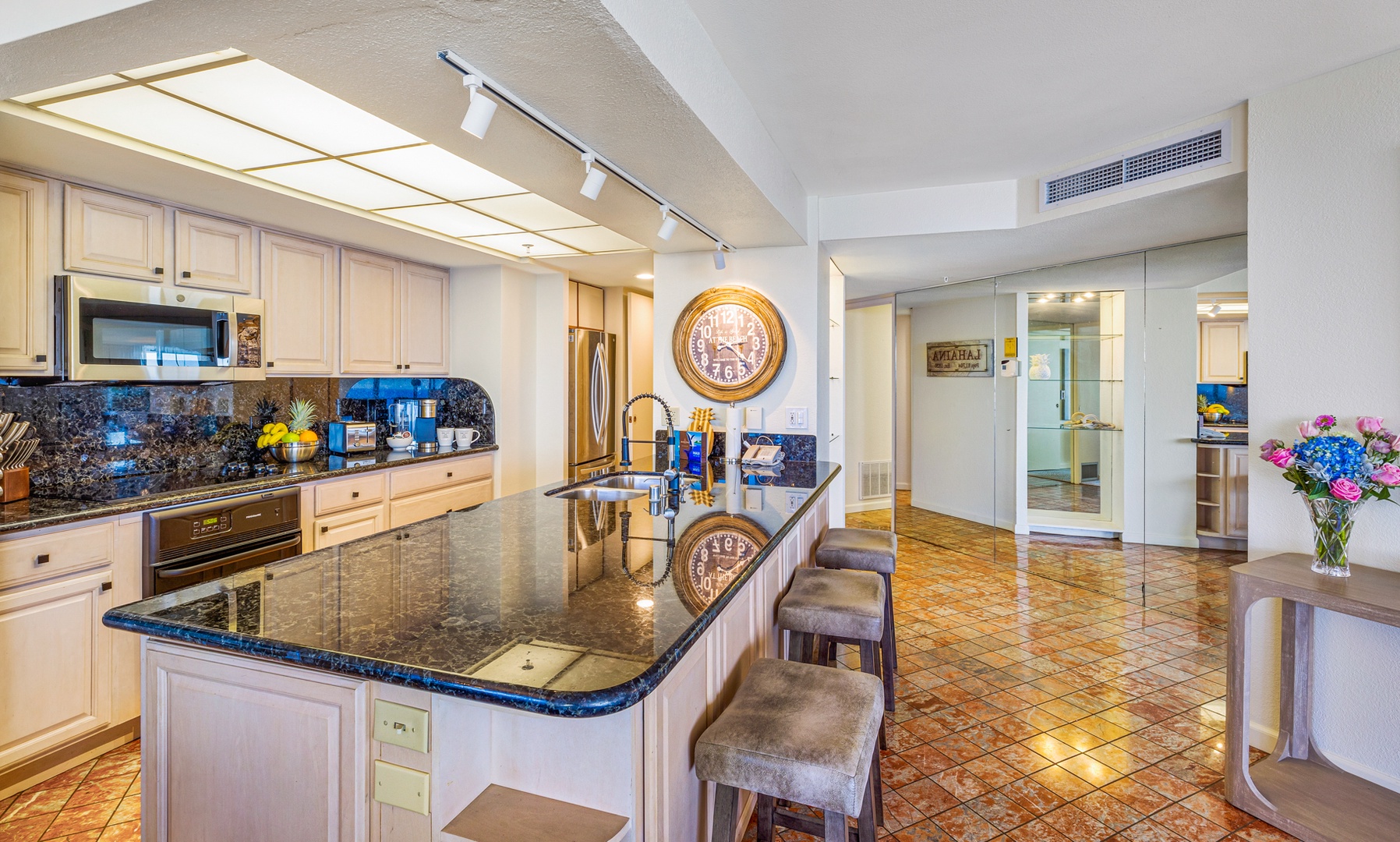 Lahaina Vacation Rentals, Kaanapali Shores 502 - Barstools line the large granite kitchen island, perfect for enjoying casual meals or a cup of coffee in a relaxed setting.