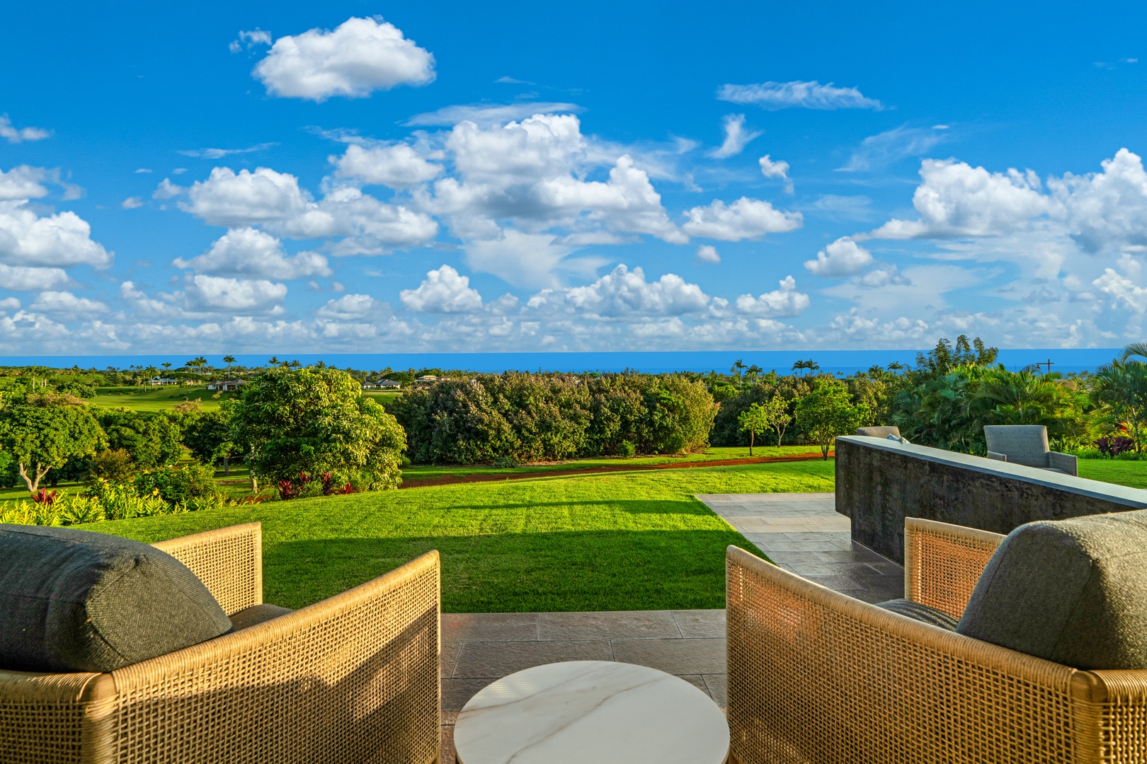 Koloa Vacation Rentals, Hale Laule'a at Kukui'ula - Relax in comfortable wicker seating while soaking in panoramic views of lush golf greens and distant ocean horizon.