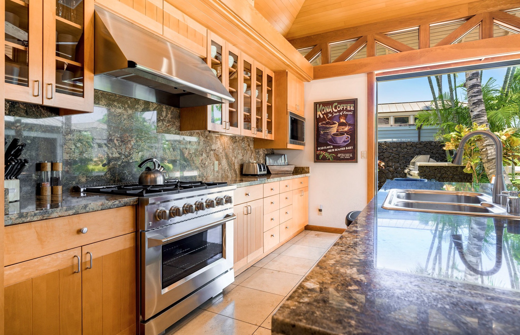 Kamuela Vacation Rentals, 3BD Na Hale 3 at Pauoa Beach Club at Mauna Lani Resort - The kitchen, a gourmet's dream featuring granite countertops, a spacious island, and premium appliances, including a 6-burner gas stove.