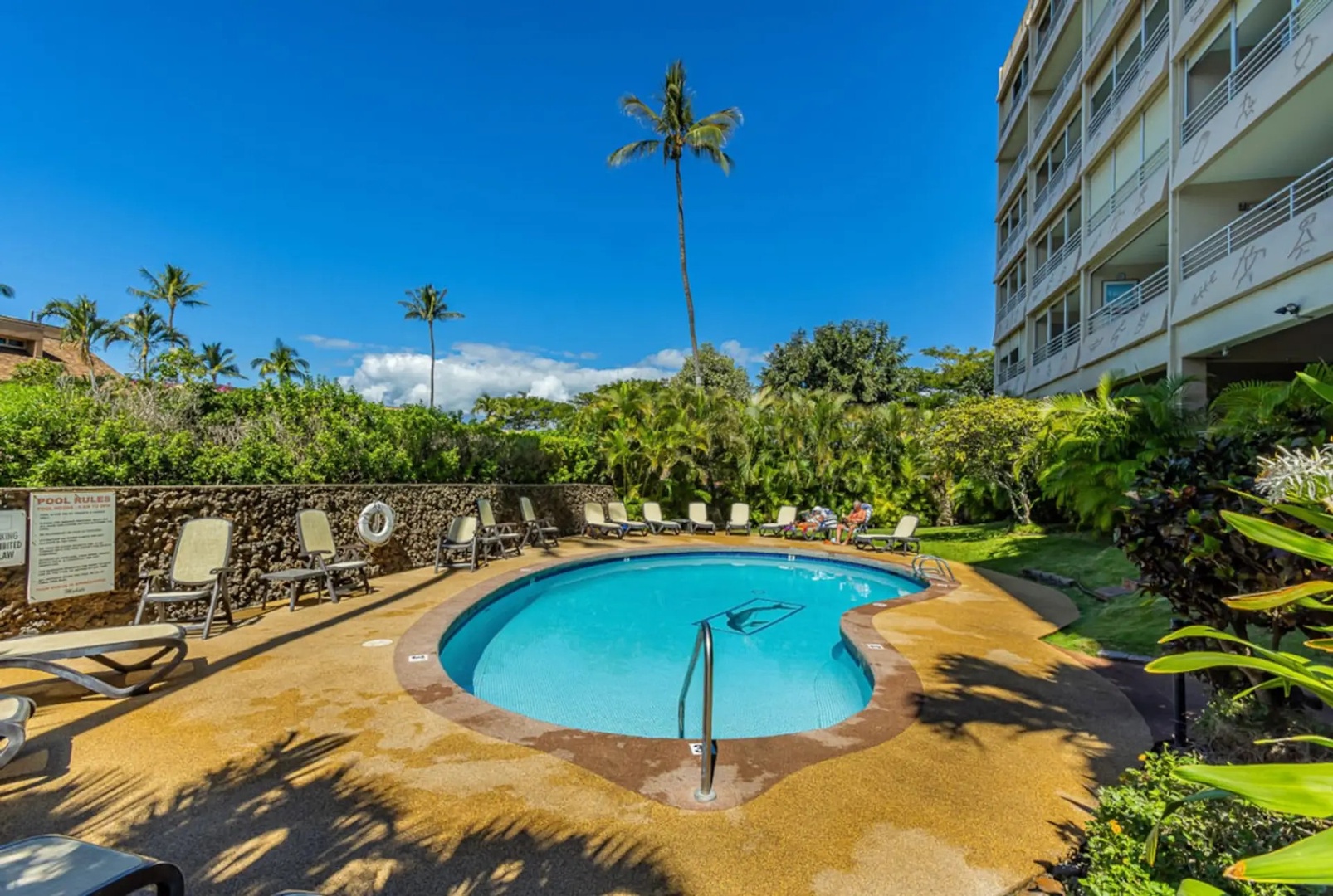 Kihei Vacation Rentals, Kamaole Beach Royal 610 - Slide into the pool, lava rock wall on one side and loungers on the other.