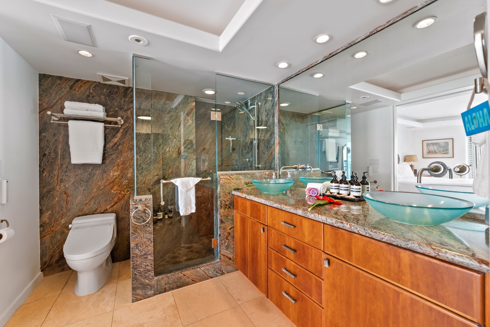 Honolulu Vacation Rentals, Kaimana Views - Luxurious bathroom with double vanity, glass-enclosed shower, and marble finishes, creating a spa-like experience for ultimate relaxation