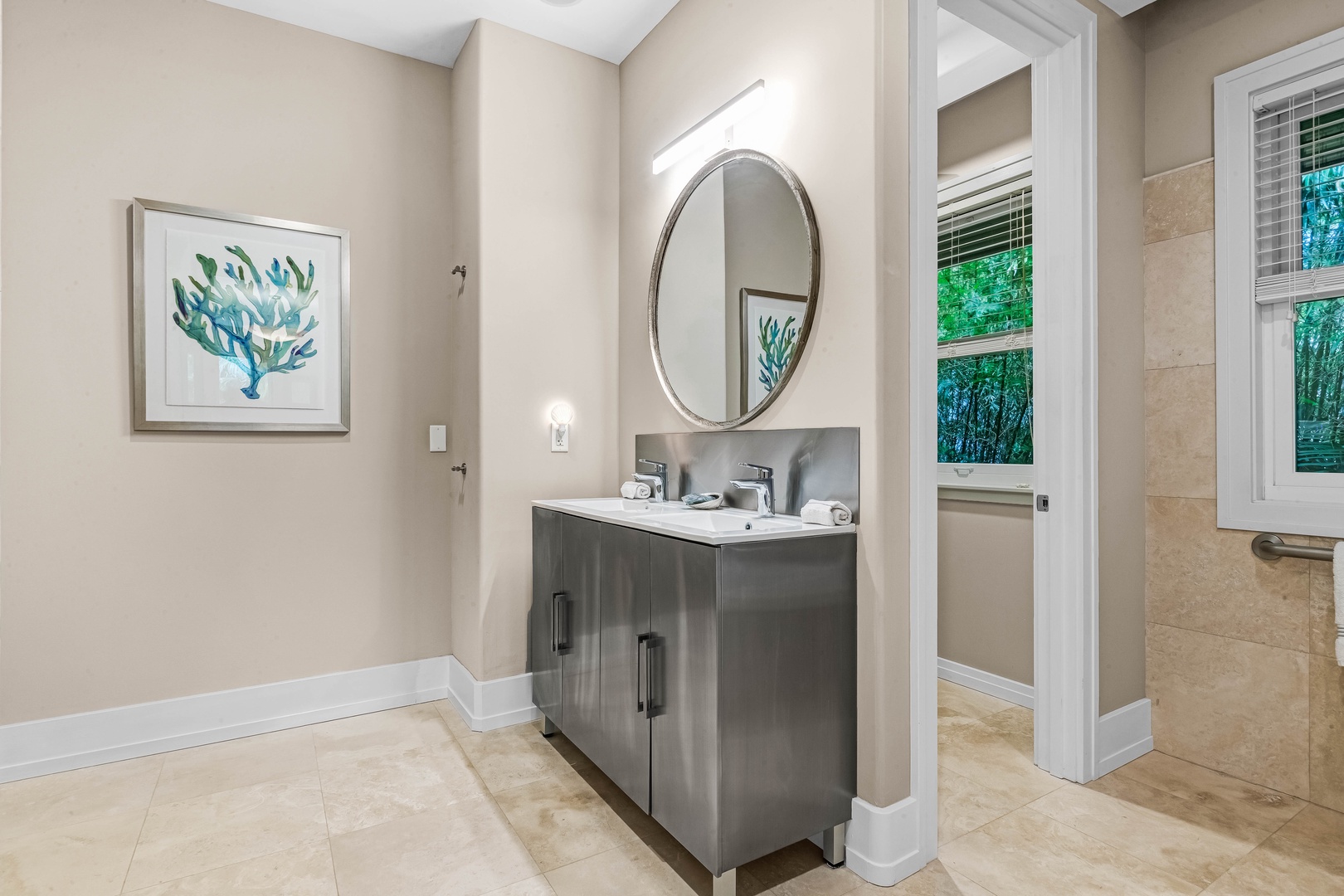 Honolulu Vacation Rentals, Pili Pono - Bathroom with modern vanity, circular mirror, and clean finishes.