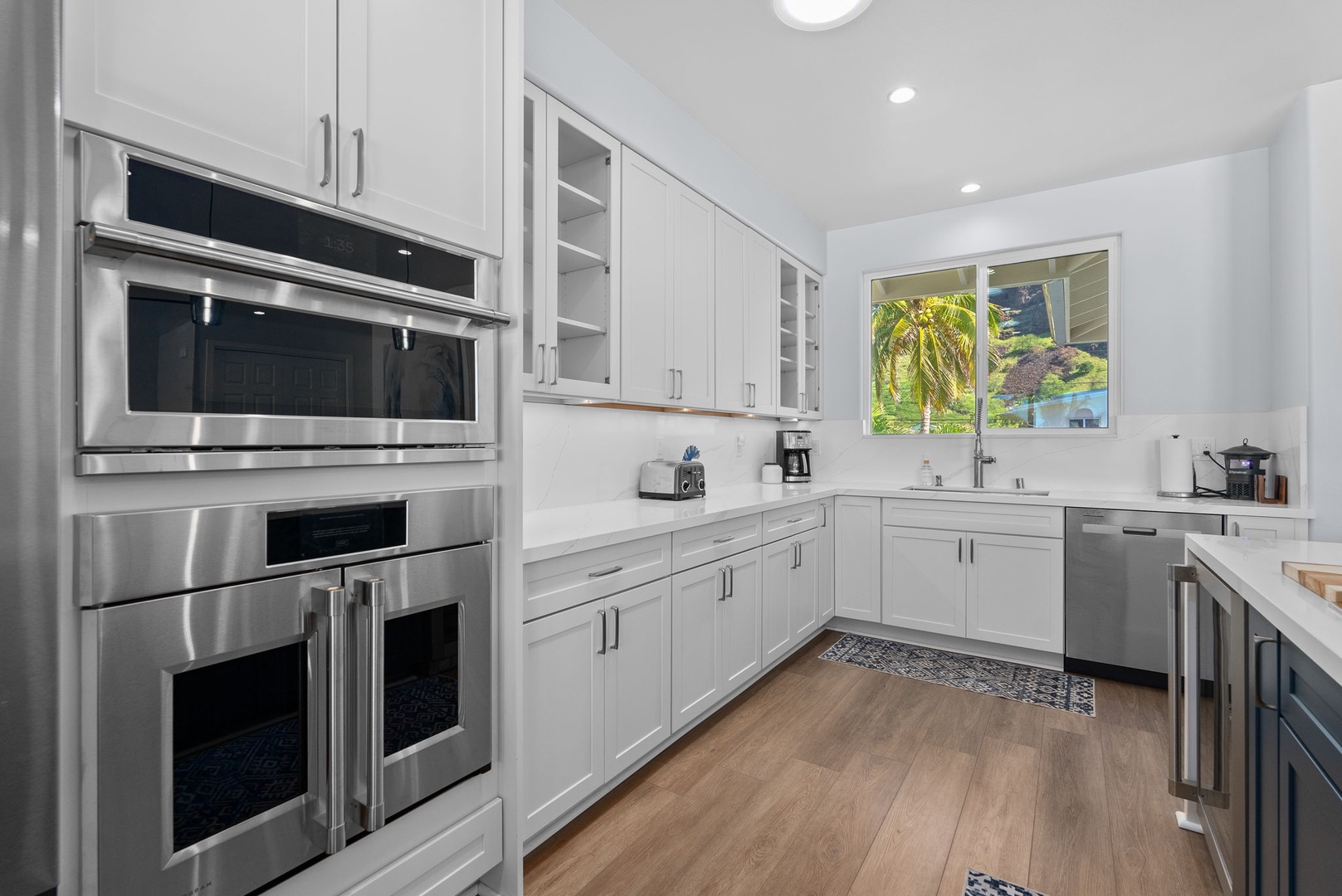 Waianae Vacation Rentals, Oceanfront Luxury Dream Estate - Upper-level kitchen features modern cabinetry, built-in oven, and a window-framed view.