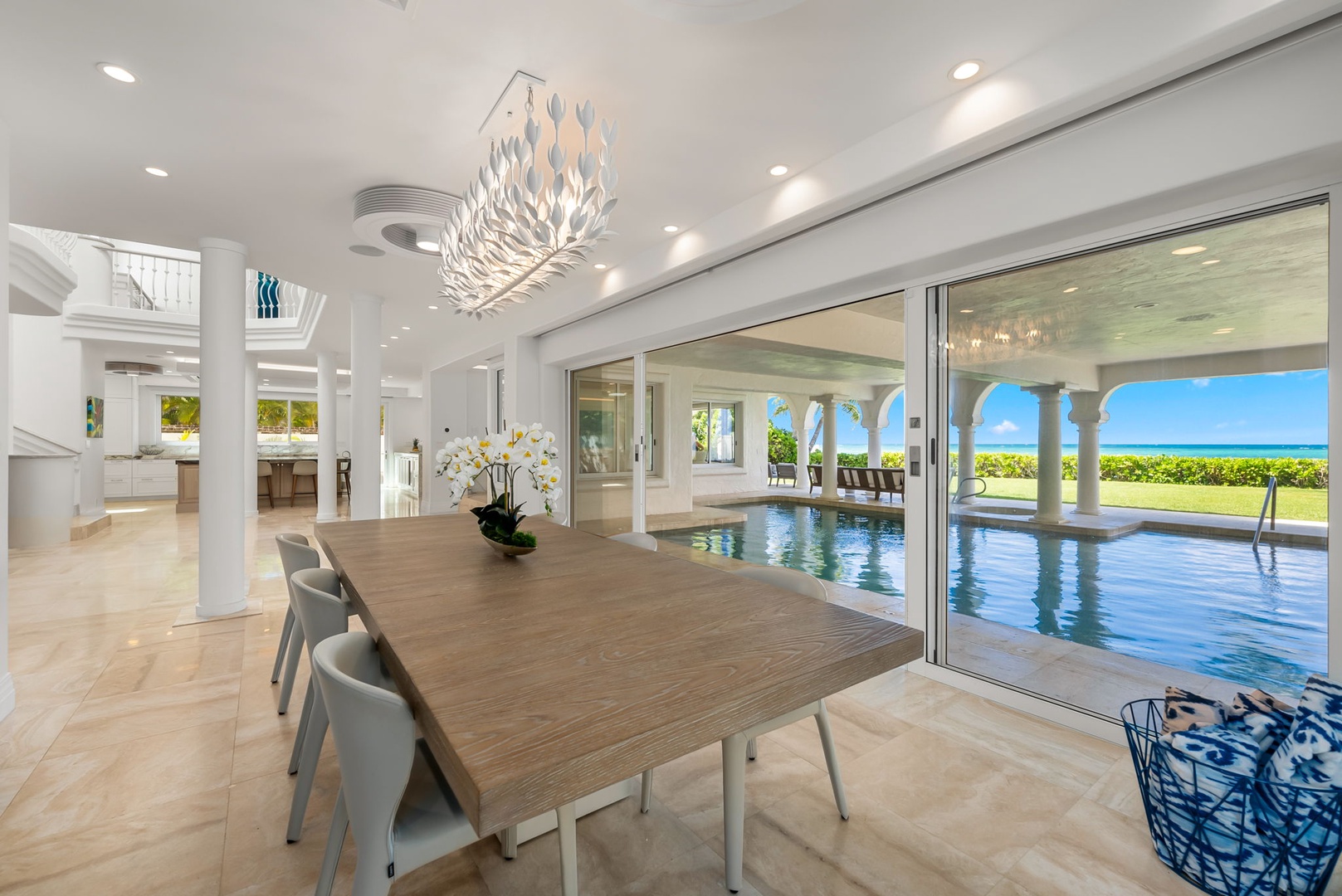 Kailua Vacation Rentals, Lanikai Sunrise Estate - Elegant dining space with seating for eight and direct access to the poolside lanai—perfect for island-style dinners.
