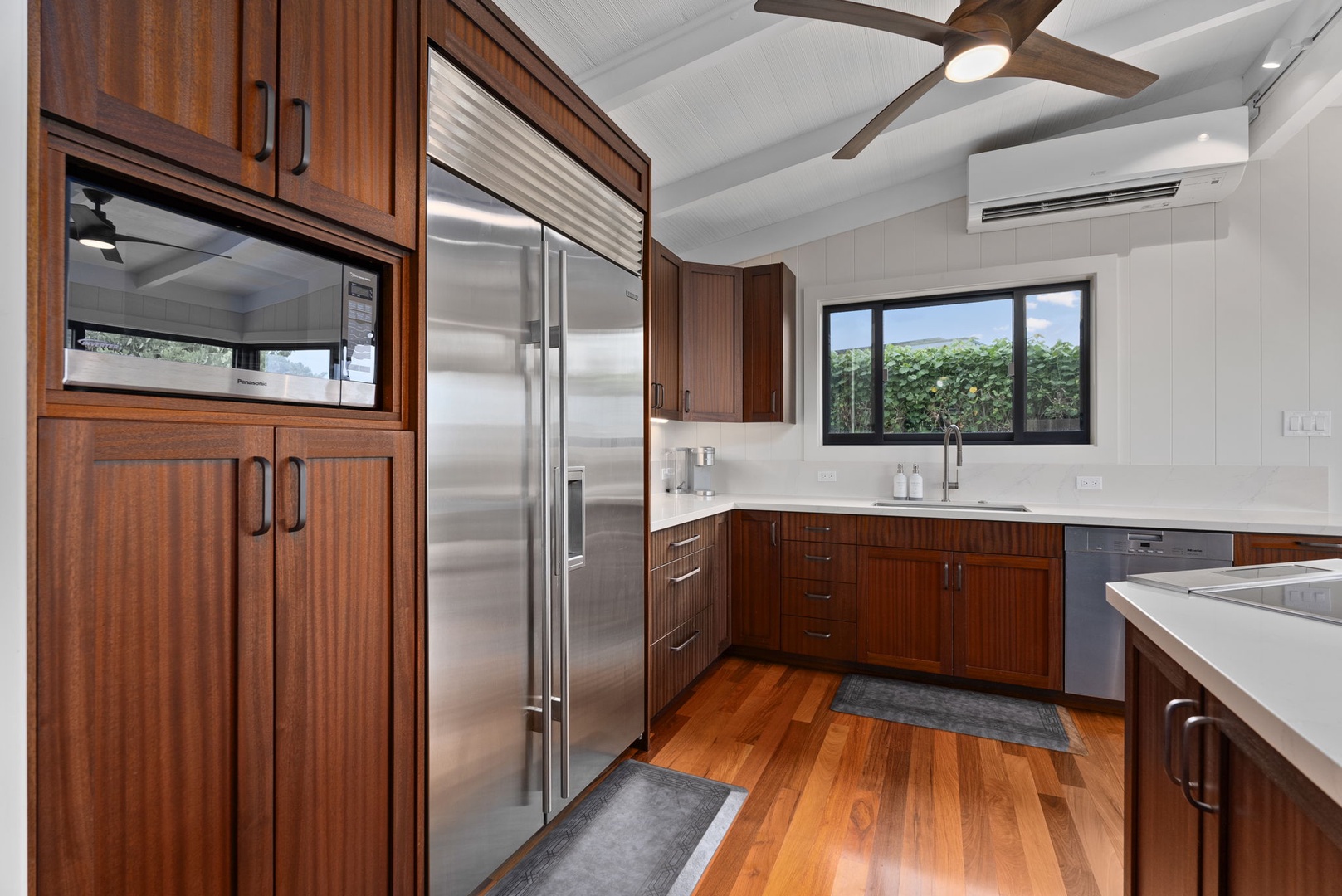 Waialua Vacation Rentals, Mokuleia Beach Villa** - The kitchen features top-tier stainless steel appliances, beautiful Brazilian wood flooring and spacious countertops for your culinary ventures.