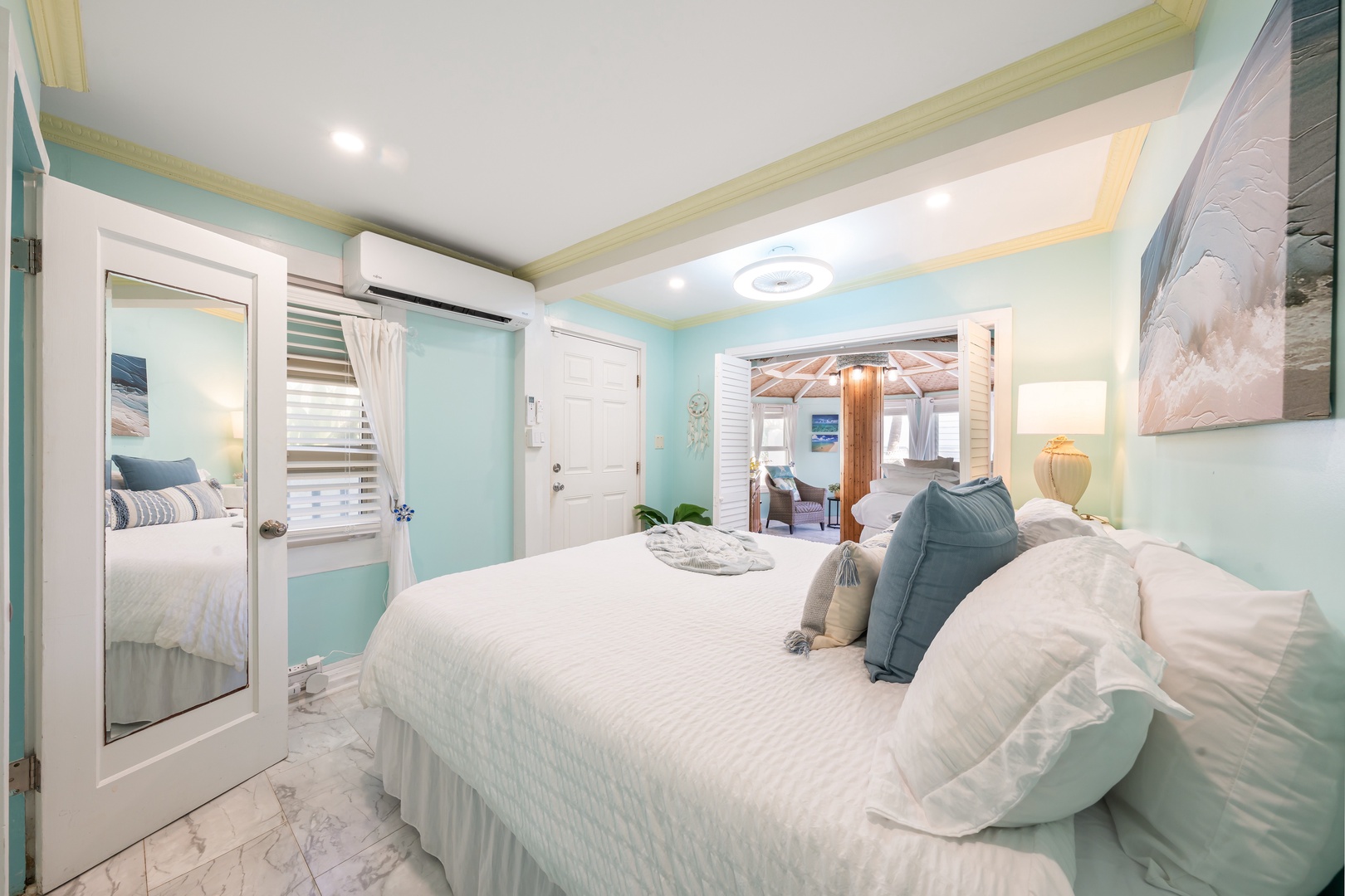 Hauula Vacation Rentals, Private Beach Paradise - Plush white linens and seafoam tones create a peaceful bedroom just steps from the beach.