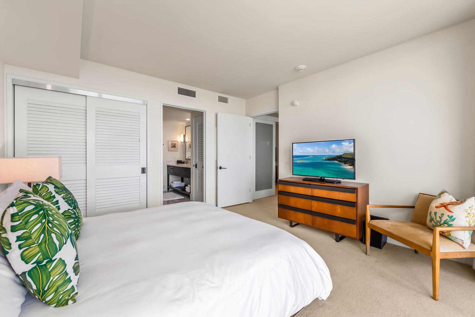 Honolulu Vacation Rentals, Kala'i 3203 - Guest bedroom with direct access to a modern bathroom, perfect for relaxing after a day of adventure.