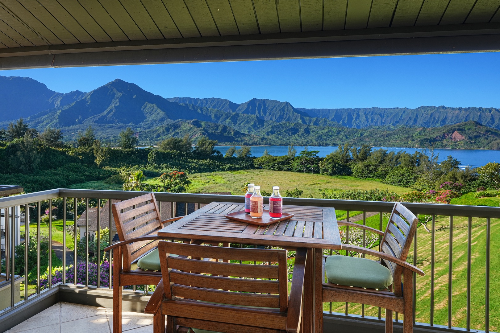 Princeville Vacation Rentals, Hanalei Bay Resort 4301/2/3 - Enjoy al-fresco dining on the lanai with scenic Hanalei Bay and mountain views. – A serene outdoor experience for meals.