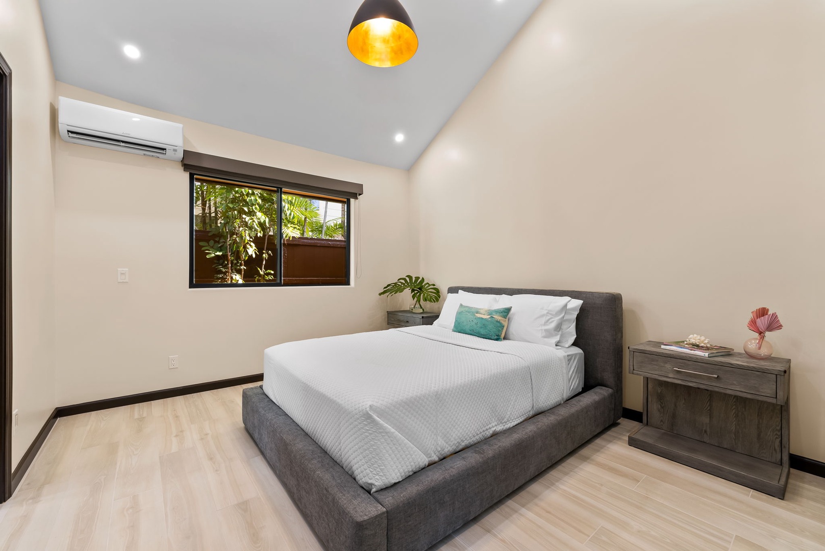 Honolulu Vacation Rentals, Kahala Zen - Bright guest bedroom featuring a king-size bed and lush outdoor views.