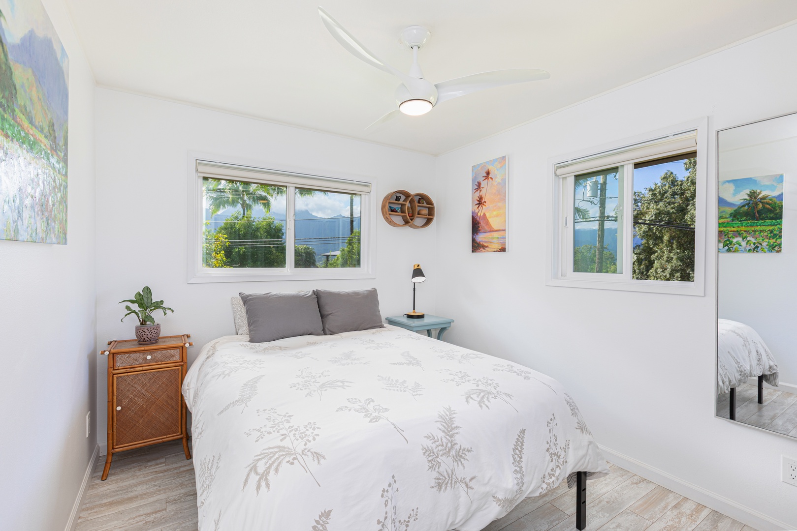 Princeville Vacation Rentals, Pohaku Kauai - Second bedroom with queen bed, dual aspect windows, and breezy mountain views.