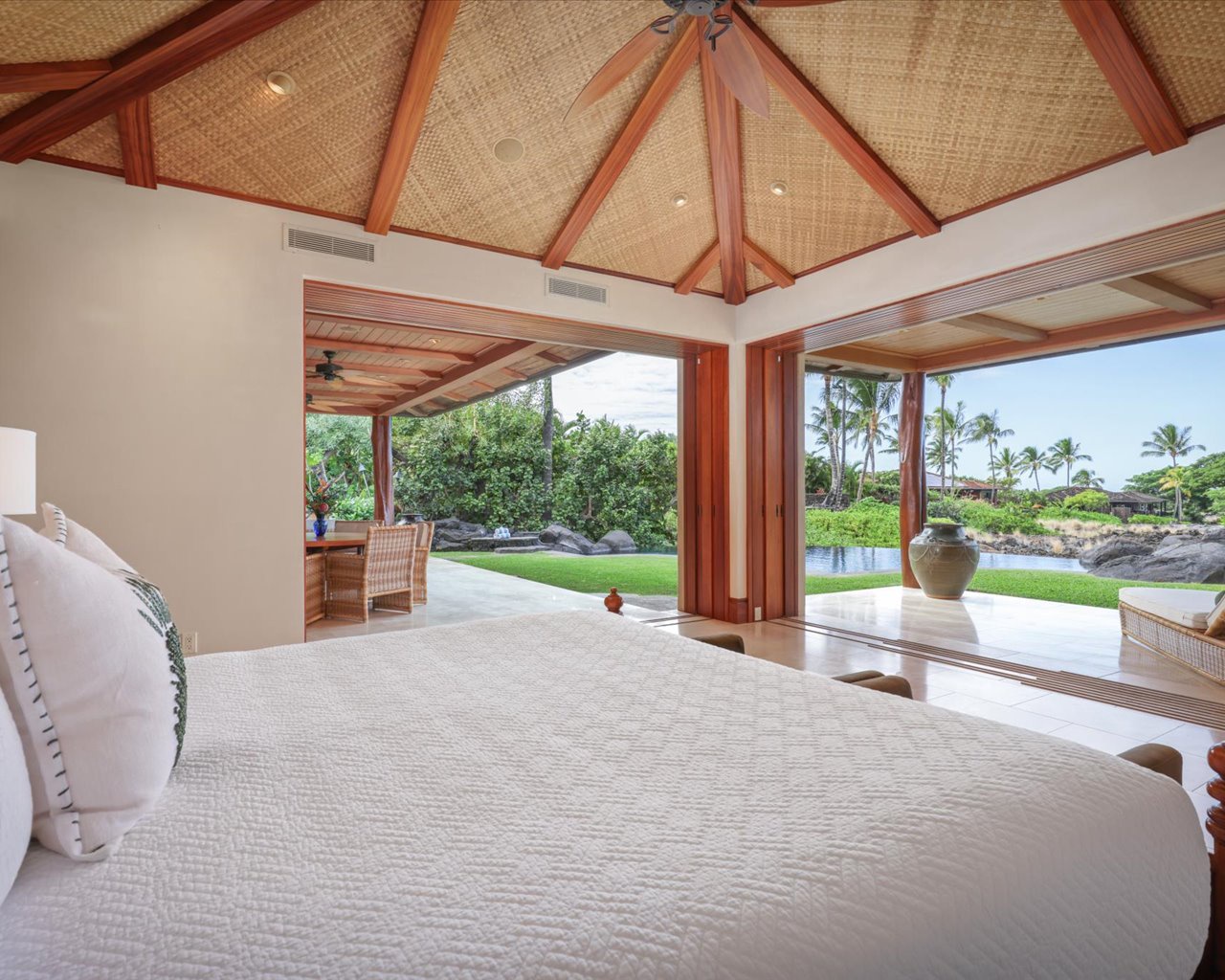 Kailua Kona Vacation Rentals, 3BD Pakui Street (131) Estate Home at Four Seasons Resort at Hualalai - Alternate view of the Primary bedroom with sliding pocket corner doors opening to two distinct lanais