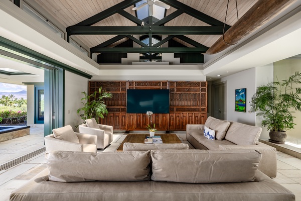 Kamuela Vacation Rentals, Canoe House & Beach Walker at Champion Ridge - Cozy seating area with high ceilings and warm lighting, perfect for unwinding and enjoying a movie night.