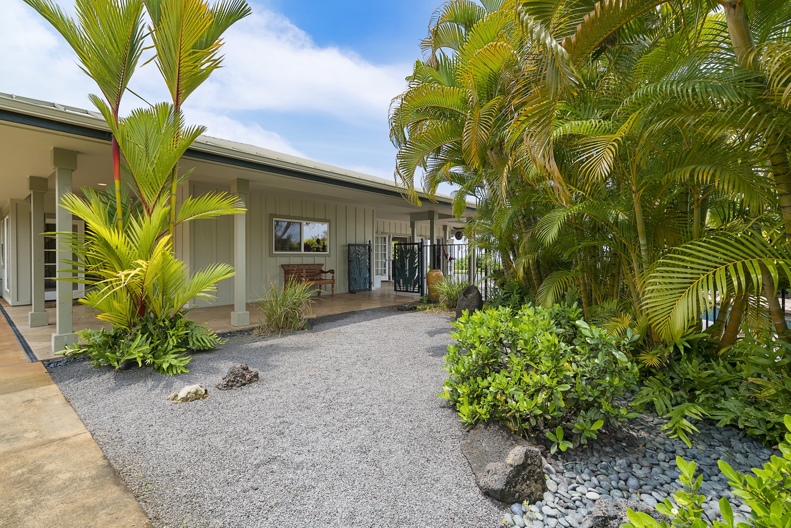 Kailua Kona Vacation Rentals, Sunset Hale - Enjoy landscaped paths, palm-lined privacy, and direct access to lanai living.