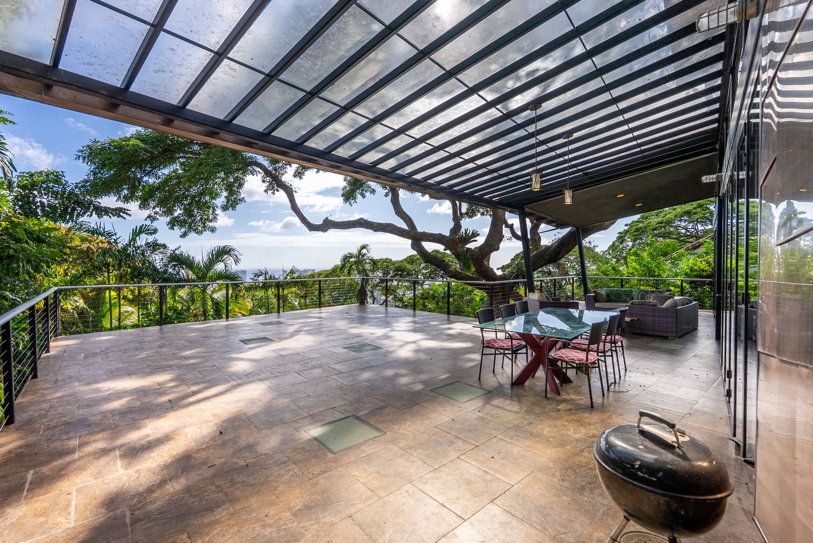 Honolulu Vacation Rentals, Tantalus Glass House (3 BD) - Your private lanai features a stunning glass ceiling, elegant dining space, and lush tropical views for perfect outdoor relaxation.