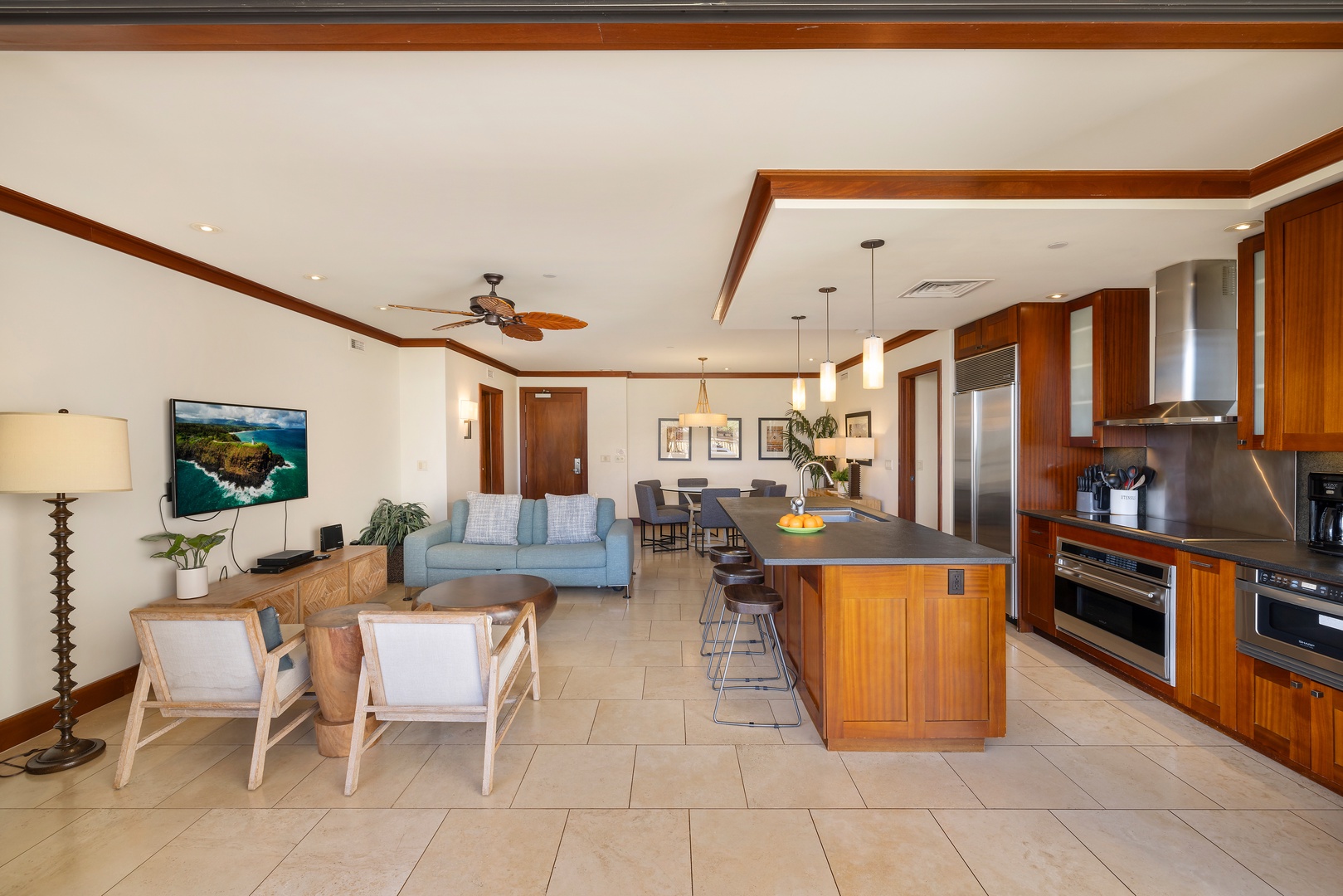 Kapolei Vacation Rentals, Ko Olina Beach Villas B403 - Relax in your open-concept living space where warm wood tones meet modern comfort—perfect for cooking together and unwinding after island adventures.