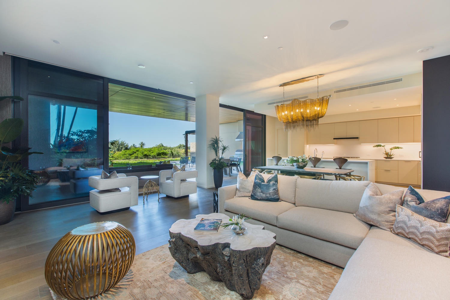 Honolulu Vacation Rentals, Park Lane Sunset Resort - Sink into plush seating while soaking up stunning garden views through floor-to-ceiling windows in this sophisticated open-plan living space.