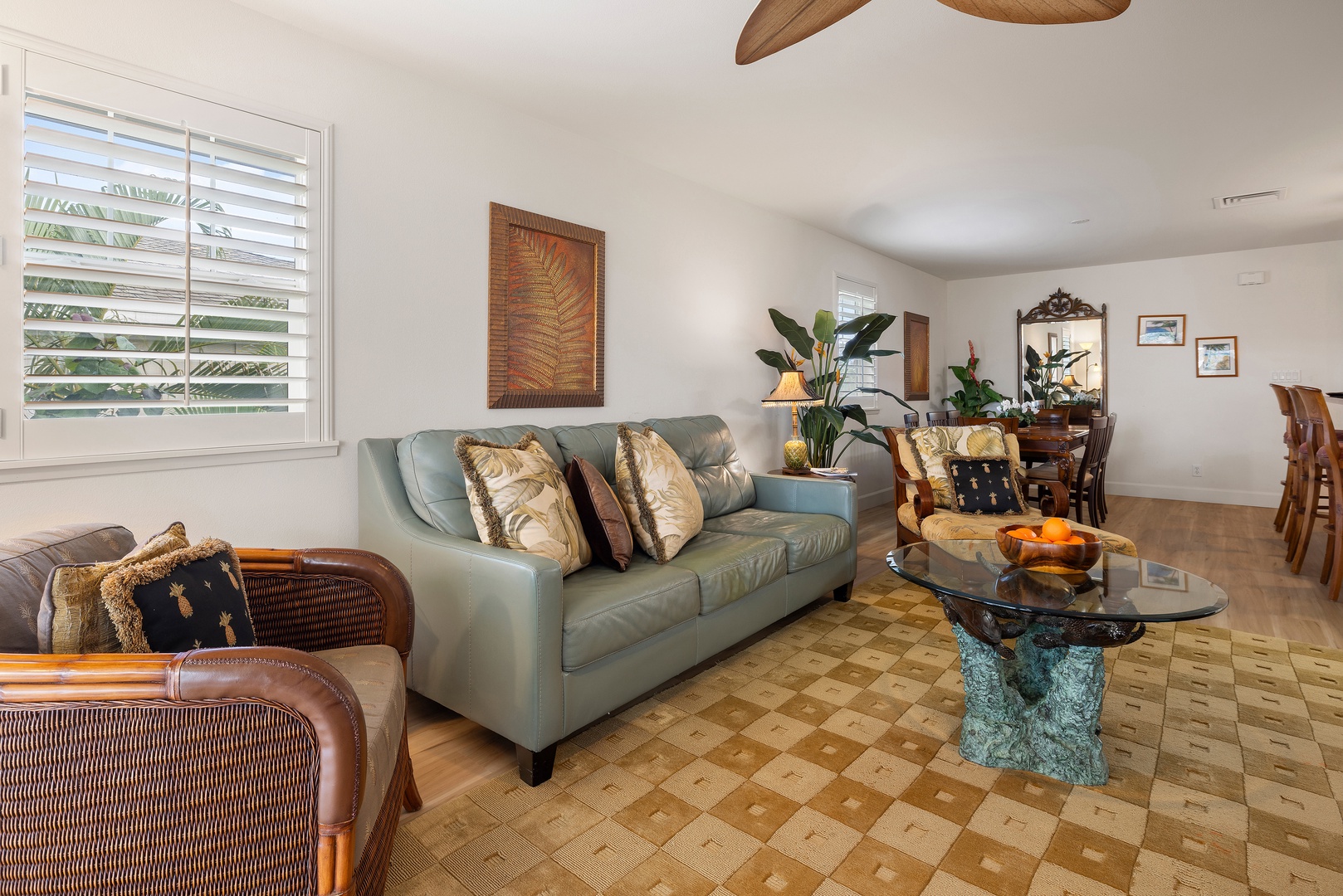 Kapolei Vacation Rentals, Ko Olina Kai 1105E - Sink into plush seating and enjoy the tropical breeze from your ceiling fan. This bright, airy living space flows seamlessly to the dining area, perfect for relaxing after a day exploring.