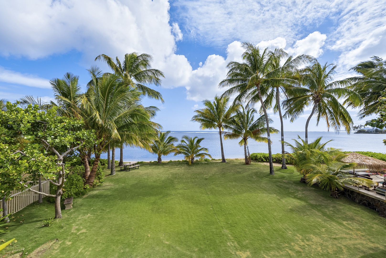 Honolulu Vacation Rentals, Honolulu Beachfront Retreat - Tropical garden area overlooking the serene ocean.