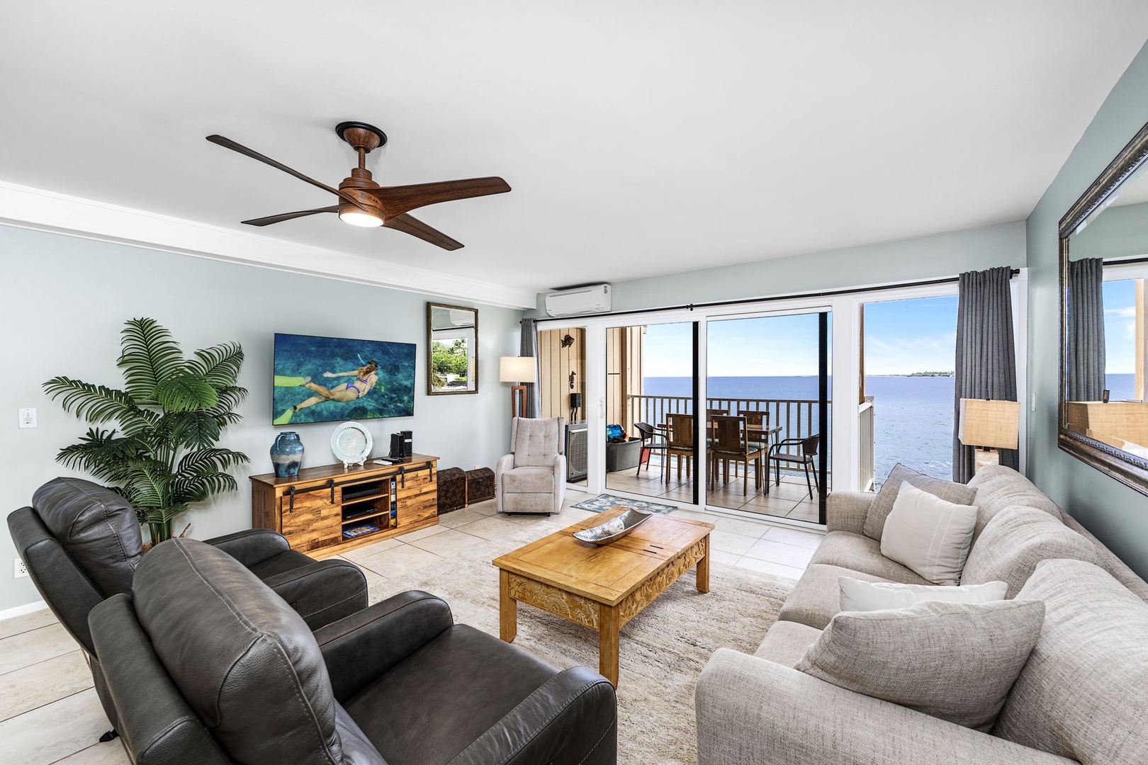 Kailua Kona Vacation Rentals, Sea Village 1105 - Air-conditioned living room with Smart TV, plush seating, and wall-to-wall ocean views.