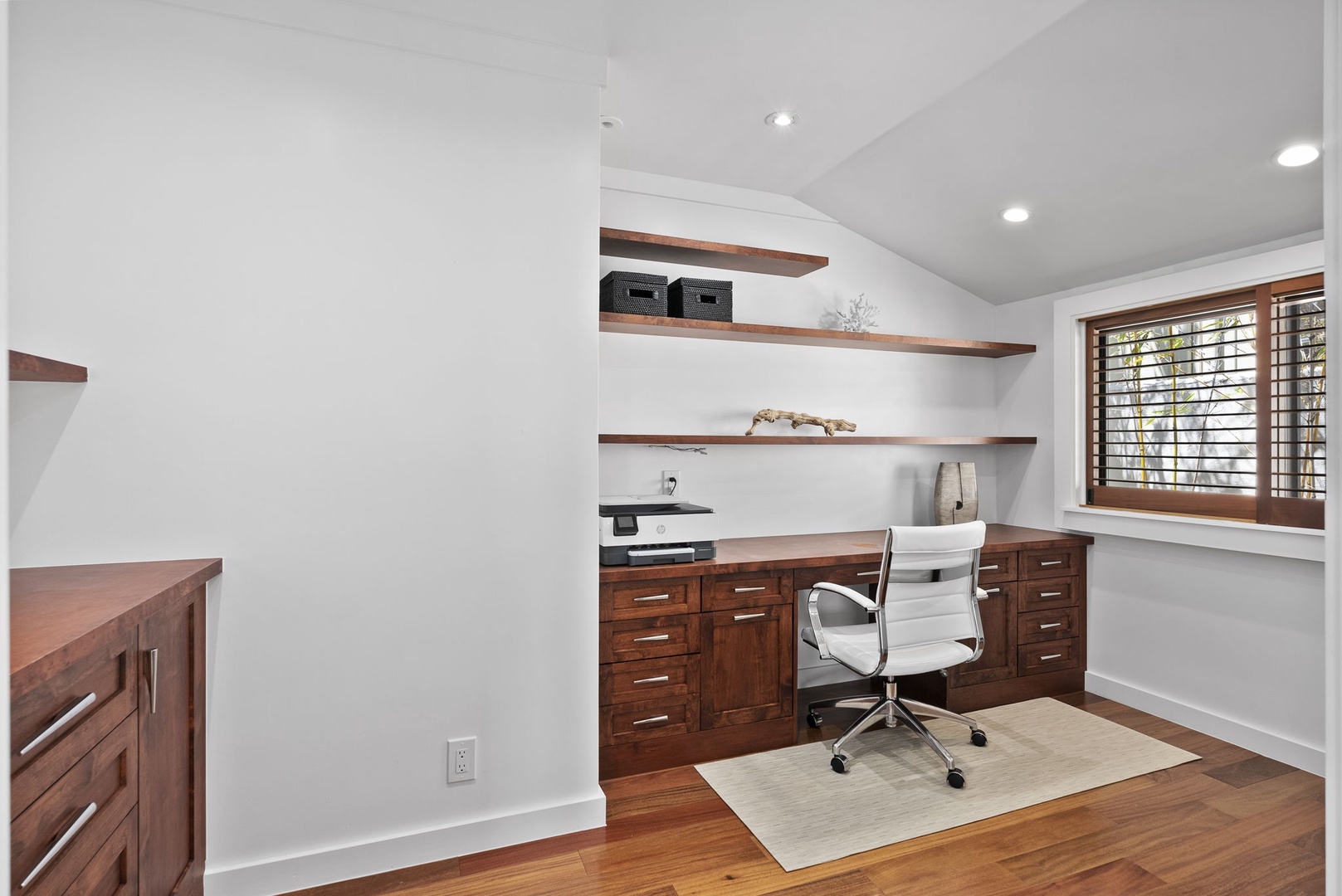 Honolulu Vacation Rentals, The Lagoon House 3BR - Dedicated workspace with rich wood cabinetry, open shelving, and natural light.