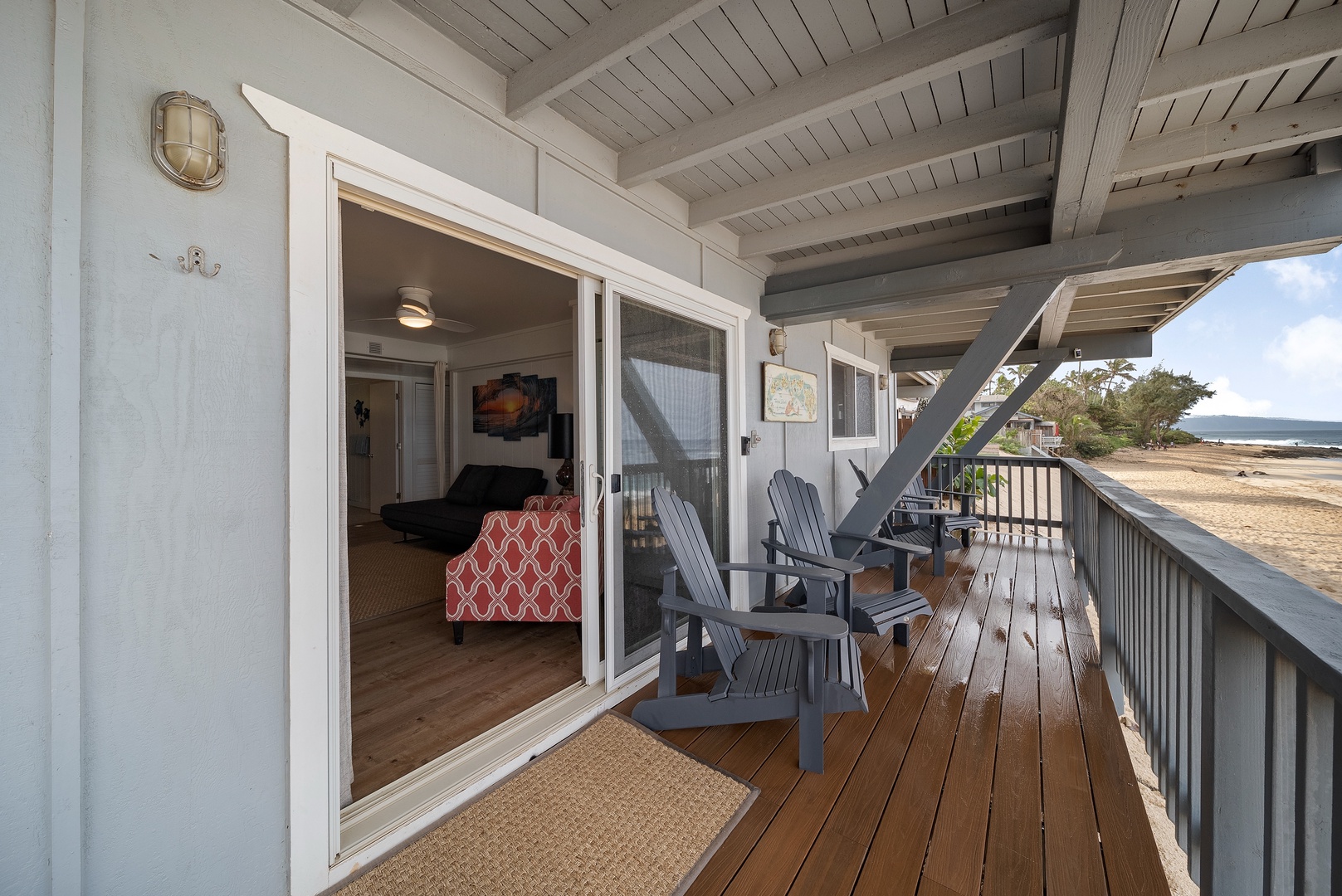 Haleiwa Vacation Rentals, Surfer's Paradise - Access to the Adirondack chairs on the deck is directly off the entertainment space
