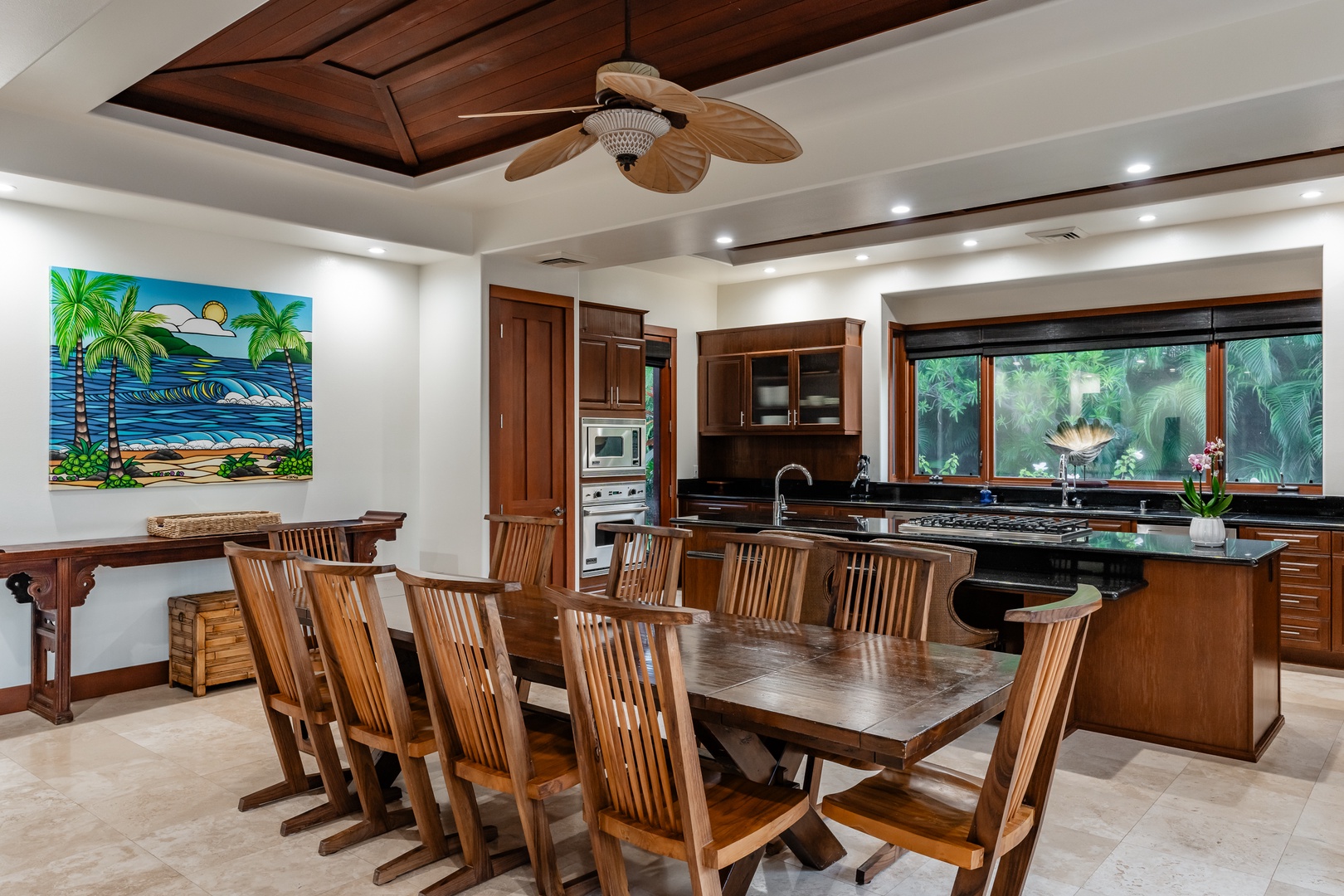 Kamuela Vacation Rentals, Mauna Lani Champion Ridge 22 - Spacious dining area with a large wooden table and chairs, adjacent to a modern kitchen, perfect for family meals and gatherings.