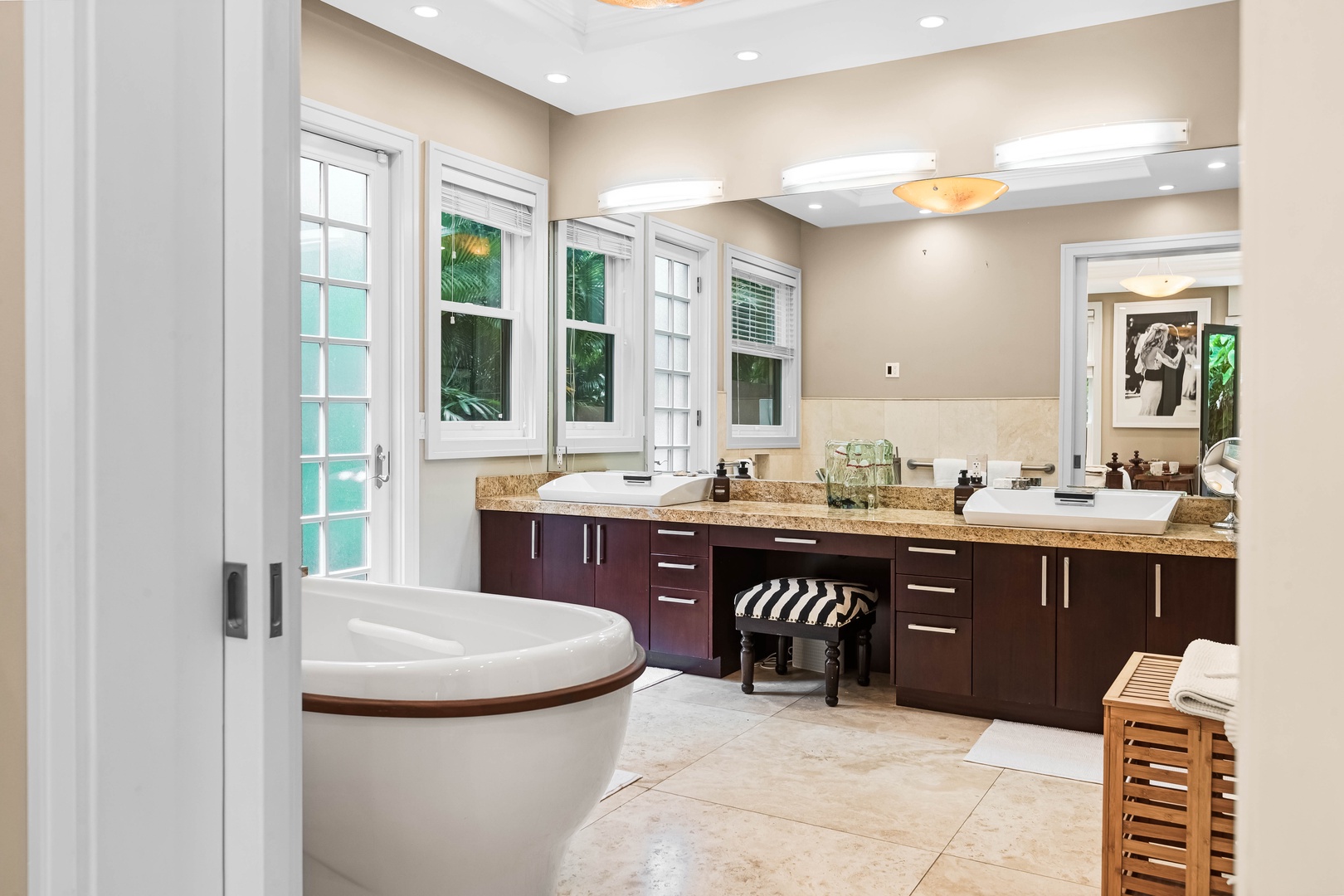 Honolulu Vacation Rentals, Pili Pono - Stylish bathroom featuring wood cabinetry and a freestanding tub.