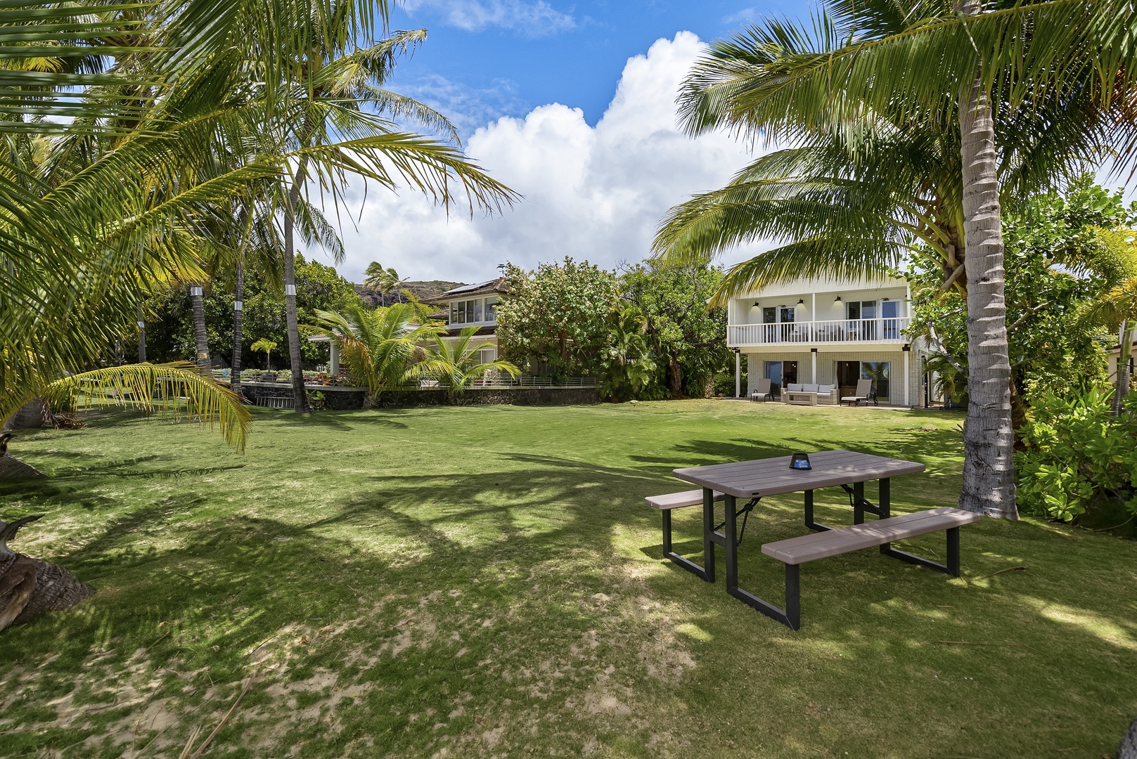 Honolulu Vacation Rentals, Honolulu Beachfront Retreat - Shared green space with picnic table, ideal for outdoor gatherings.