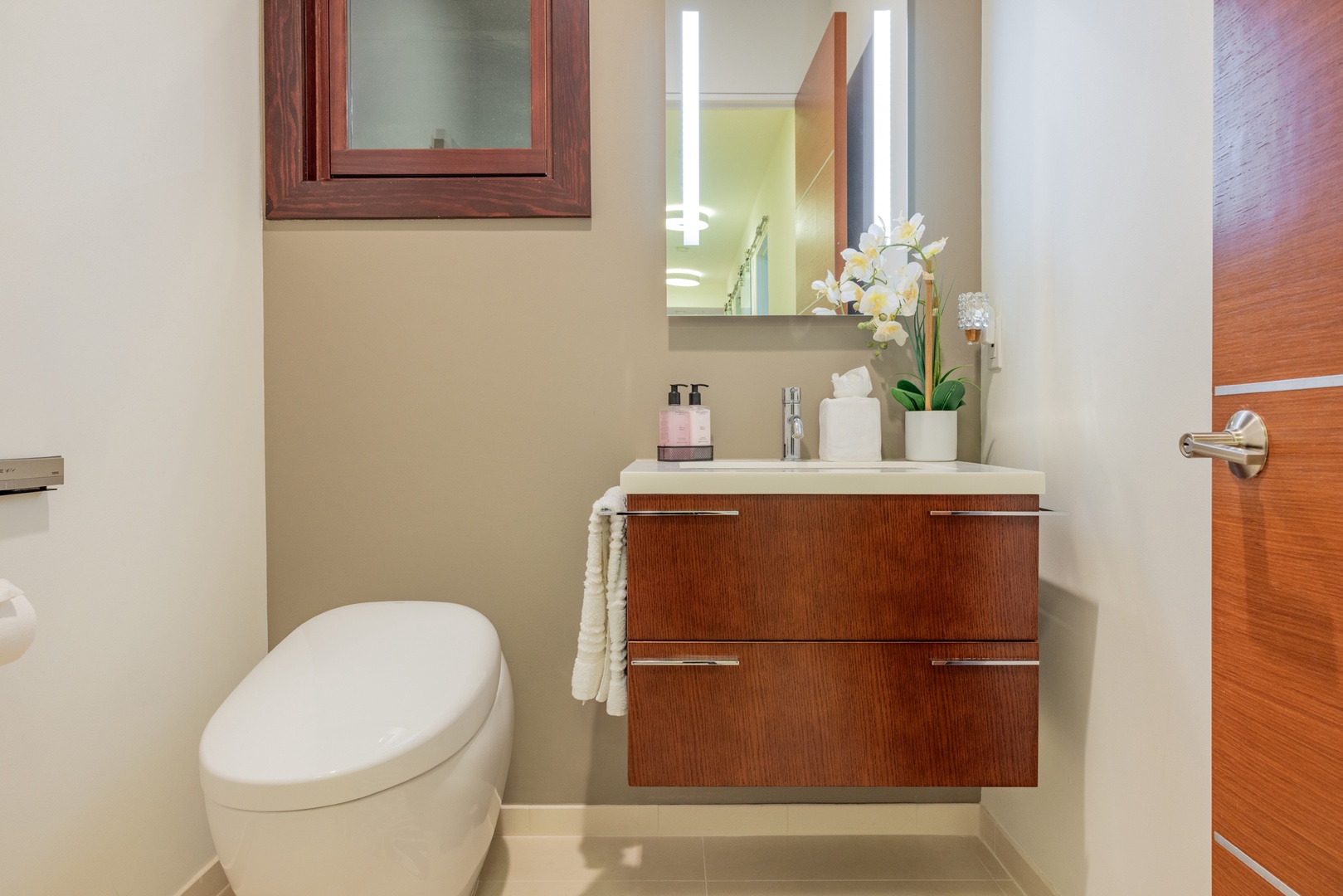 Honolulu Vacation Rentals, Kahala Grand Splendor - Sleek powder room with elegant vanity and soft lighting.