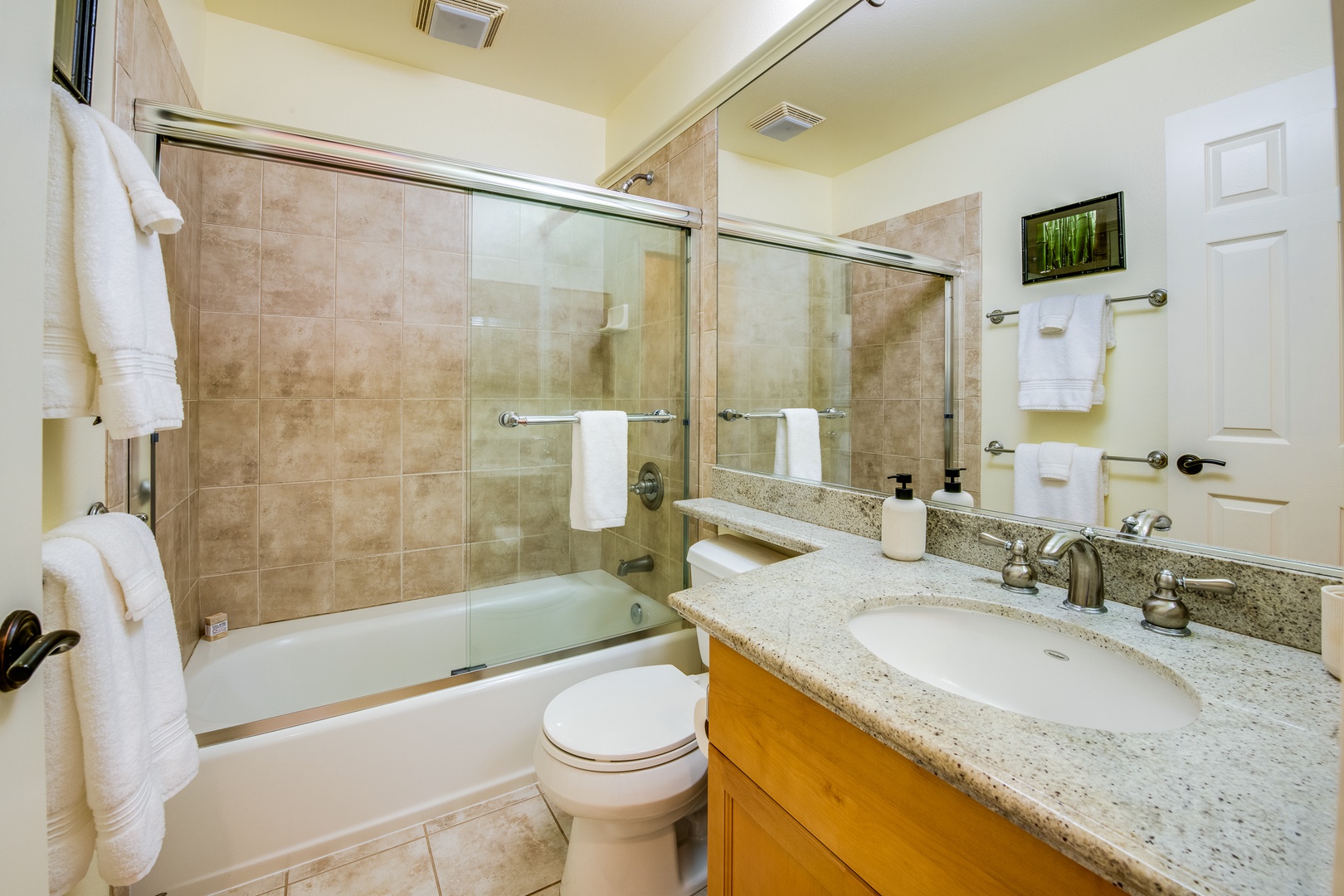 Kamuela Vacation Rentals, Mauna Lani Fairways #204 - The guest suite includes a private bath with a tub/shower combo, granite countertop, and tile accents for total comfort.