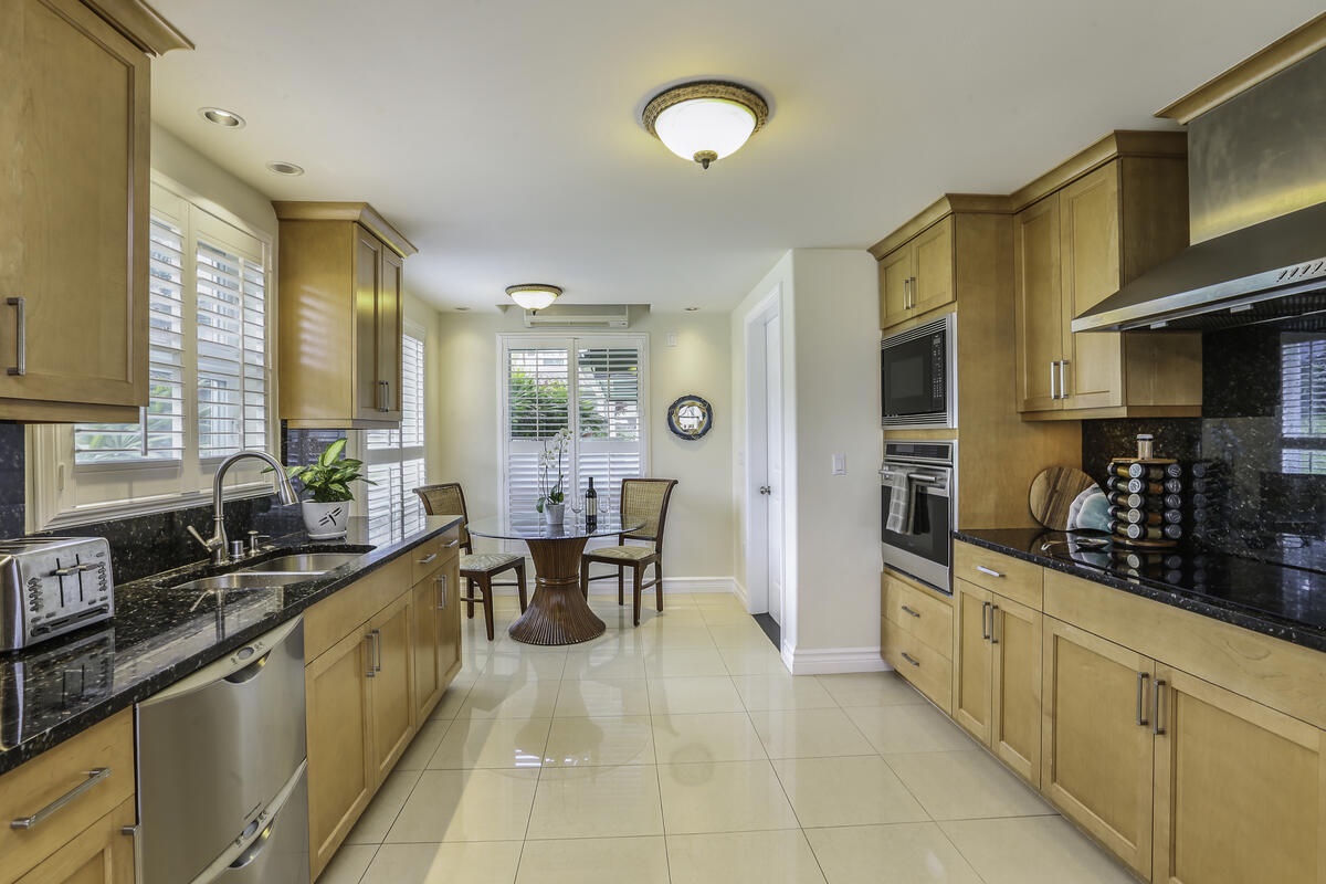 Princeville Vacation Rentals, Ho'onanea - The fully equipped Chef’s kitchen, includes granite countertops, a Wolf gas range and sub-zero fridge.