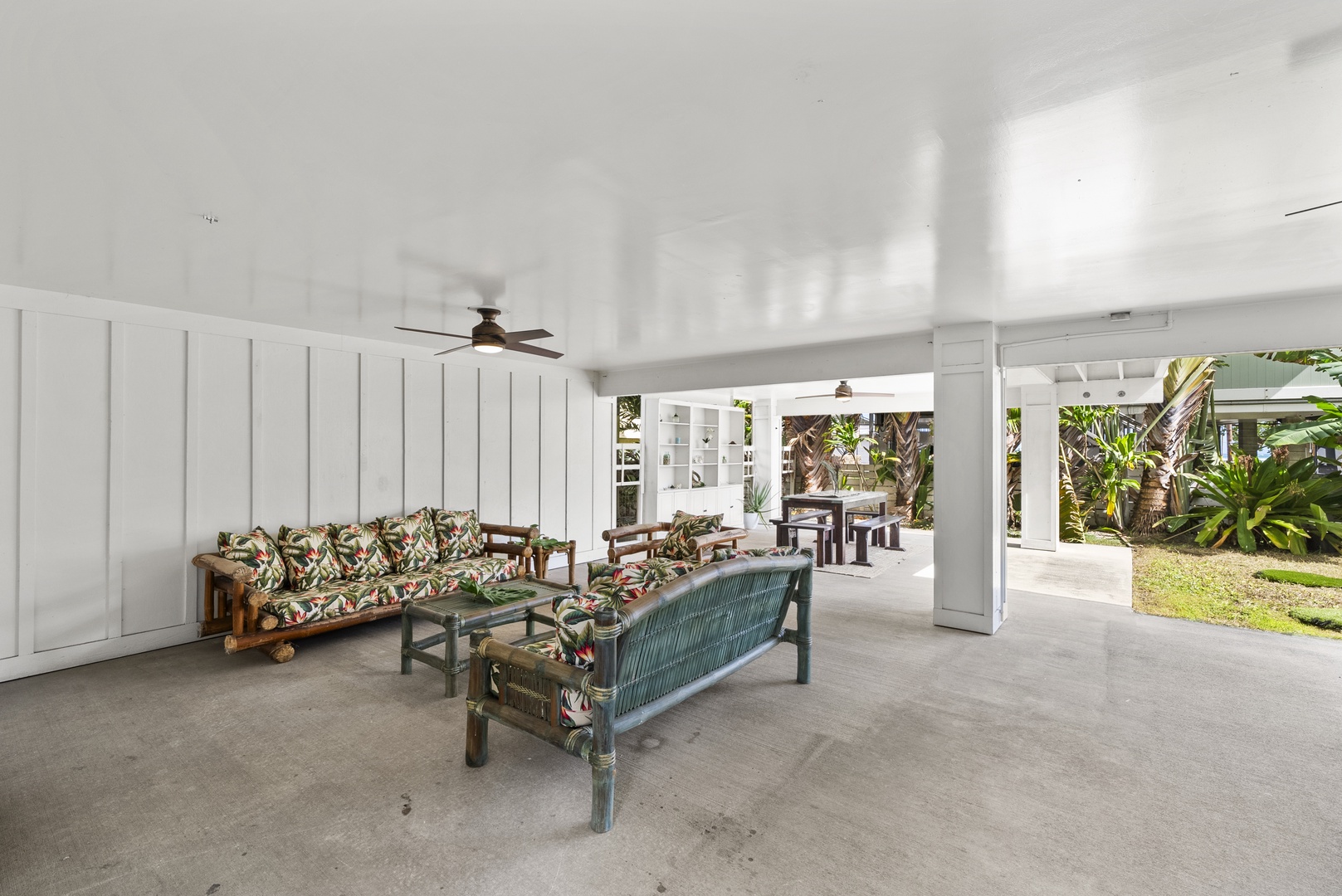 Kaaawa Vacation Rentals, Ka'a'awa Hale - Spacious lanai leading to the yard, perfect for lounging and enjoying the fresh air.