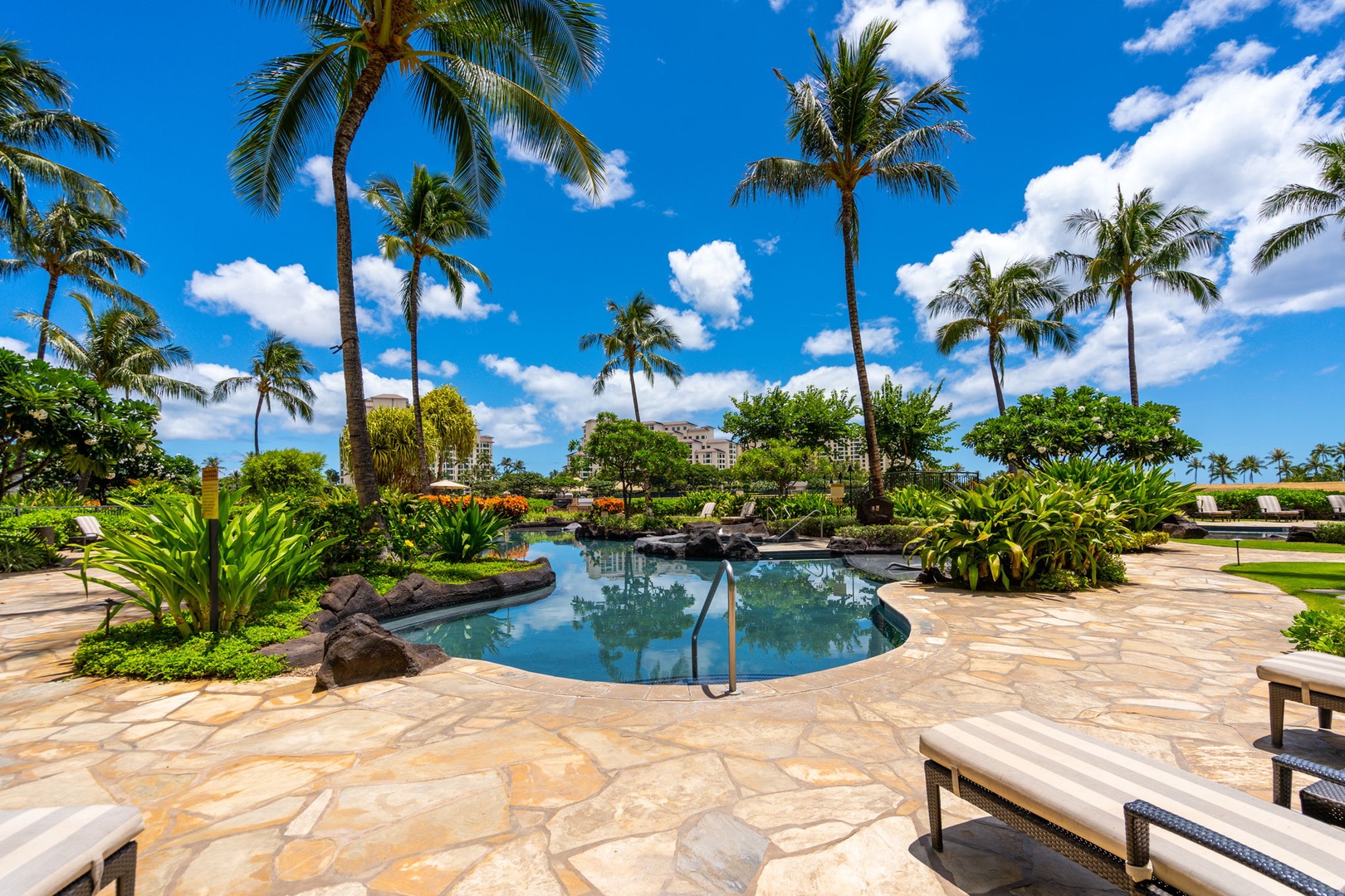 Kapolei Vacation Rentals, Ko Olina Beach Villas B604 - Paradise awaits with this stunning resort pool surrounded by swaying palms and tropical landscaping under brilliant blue skies.