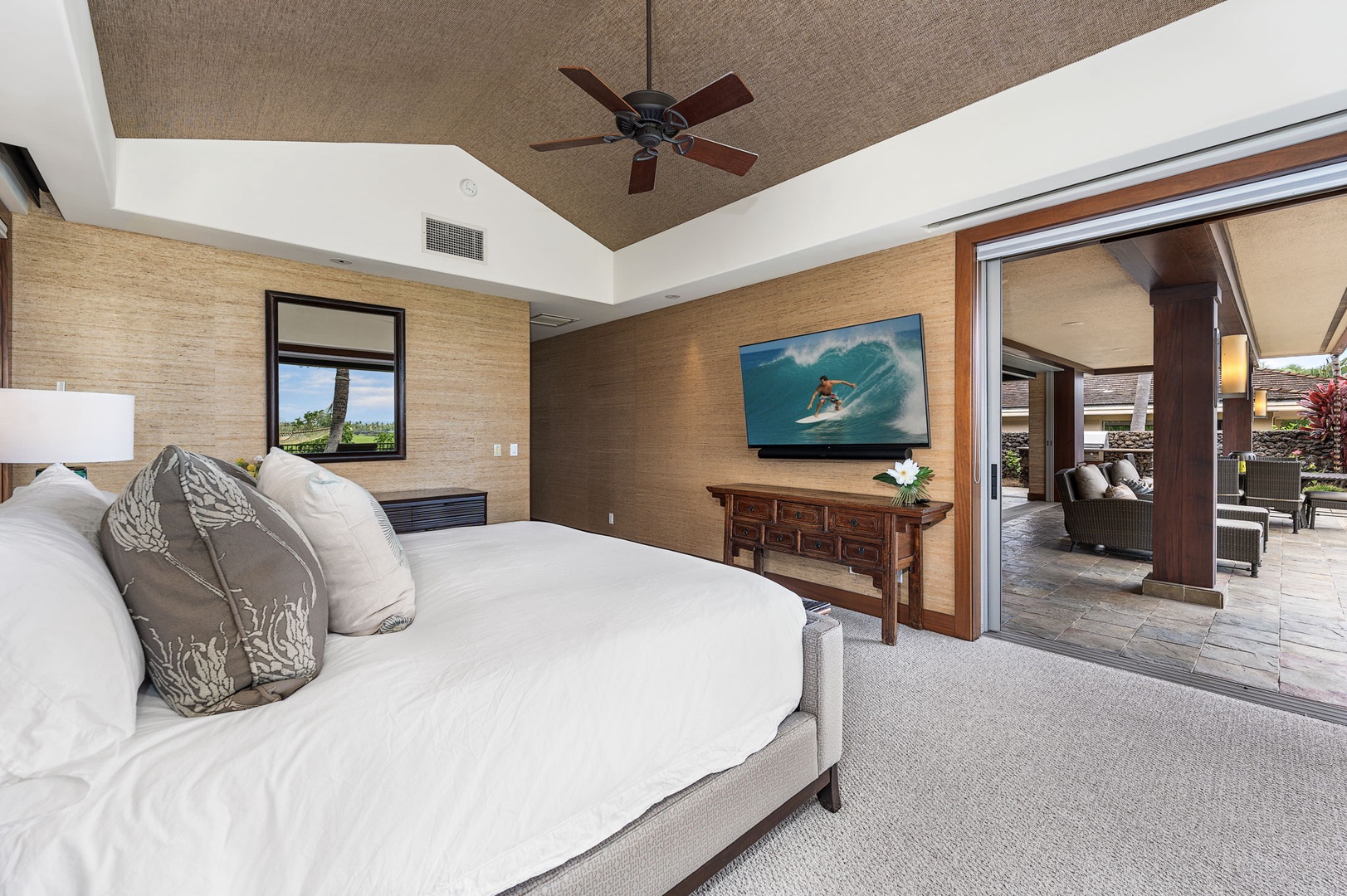 Kailua Kona Vacation Rentals, 3BD Pakui Street Estate (149) at Hualalai Resort - A king in the primary suite, TV on the wall, the lanai open through the doors alongside.
