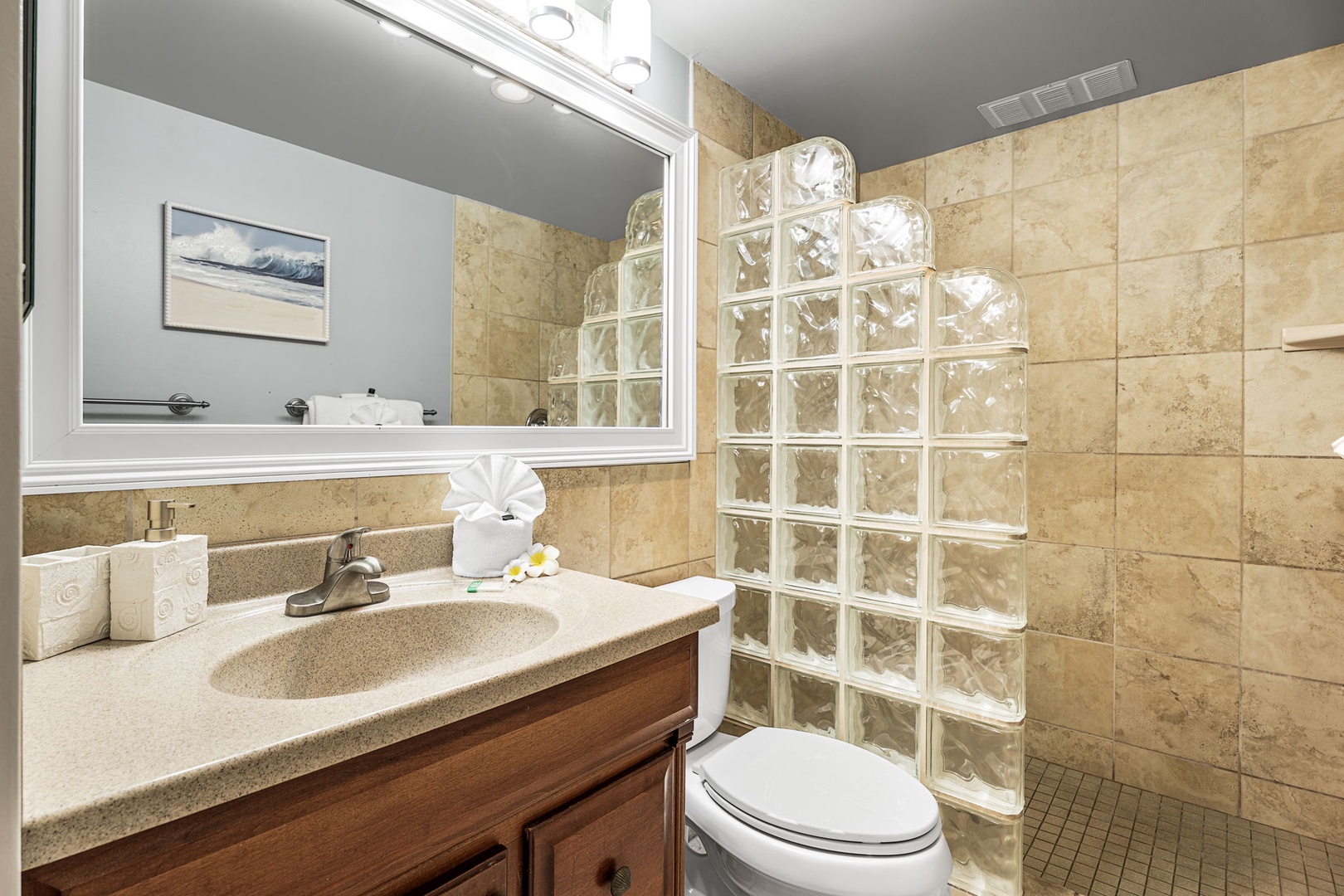 Kailua Kona Vacation Rentals, Sea Village 1105 - Stylish main bathroom with tiled walk-in shower and glass block accents.