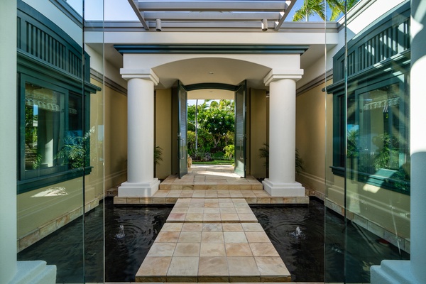 Kamuela Vacation Rentals, Canoe House & Beach Walker at Champion Ridge - Grand entrance with stately columns and a walkway over water features.