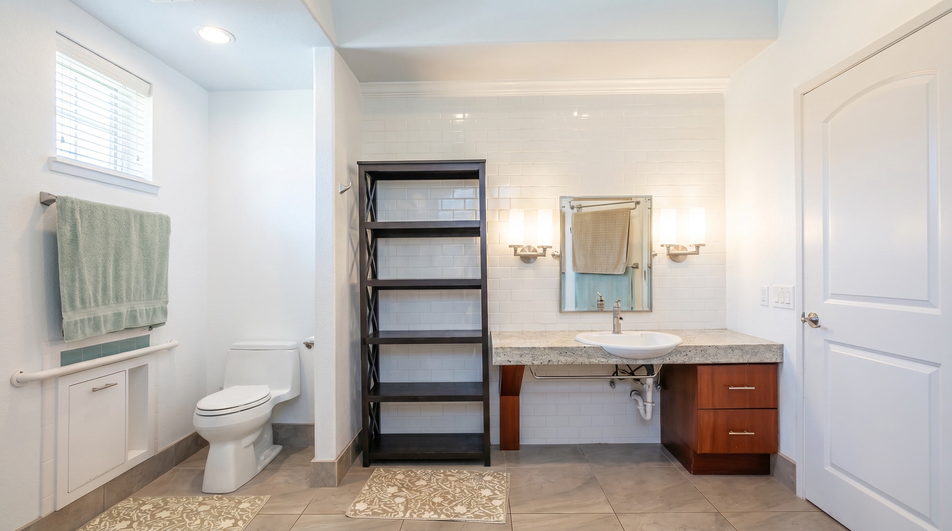 Spread out at a vanity with open shelves for towels and everything you packed.