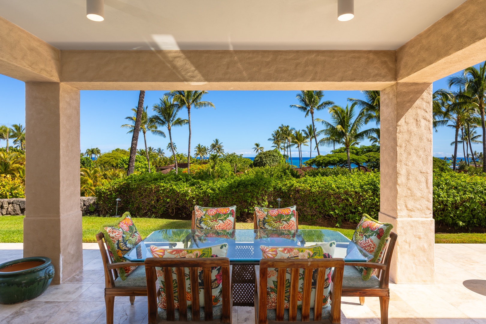 Kailua Kona Vacation Rentals, 2BD Hillside Villa (4102) at Hualalai Resort - Covered lanai dining table surrounded by lush tropical gardens with a peek of the Pacific.