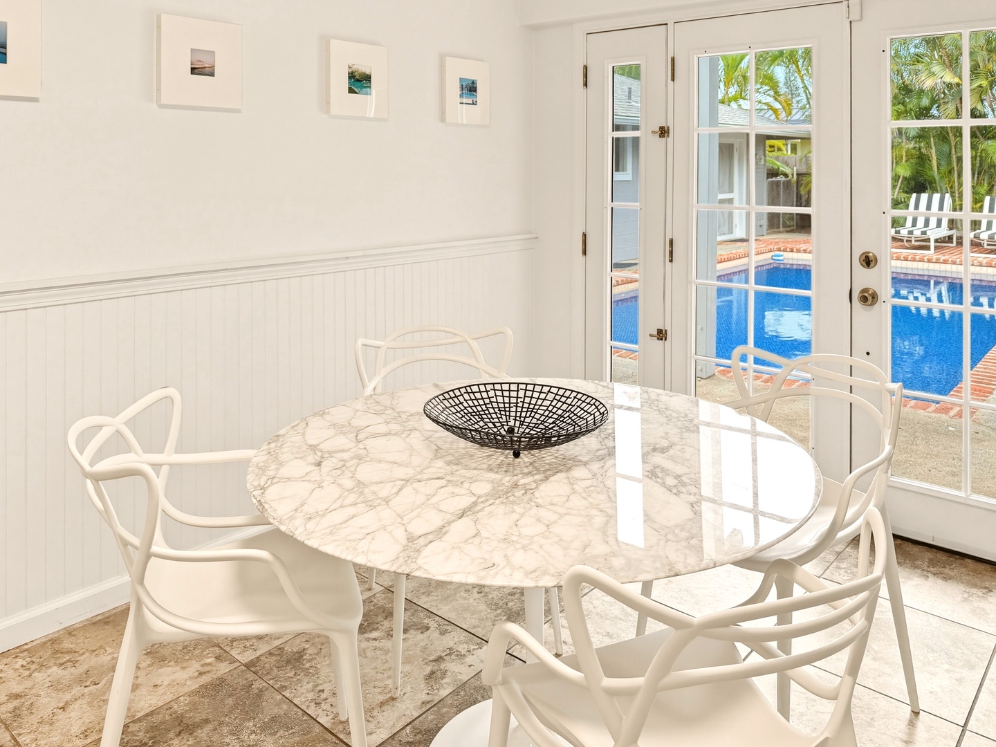 Honolulu Vacation Rentals, Ho'okipa Villa - Your elegant breakfast nook features a marble table with poolside views through French doors, perfect for morning coffee or evening meals.