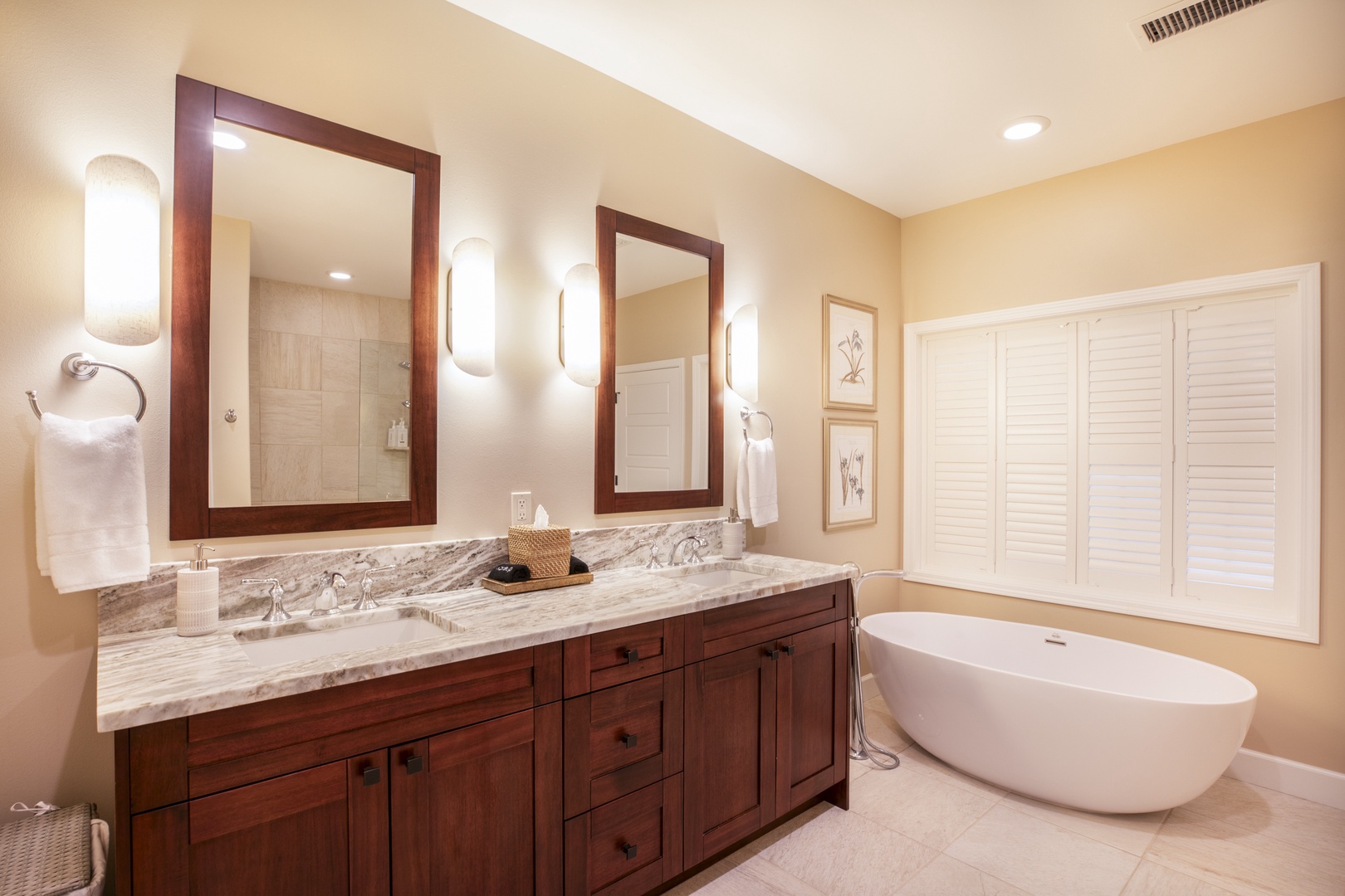 Kamuela Vacation Rentals, Mauna Lani KaMilo #503 - Unwind in the beautifully appointed ensuite bathroom featuring granite counters and warm wood cabinetry.
