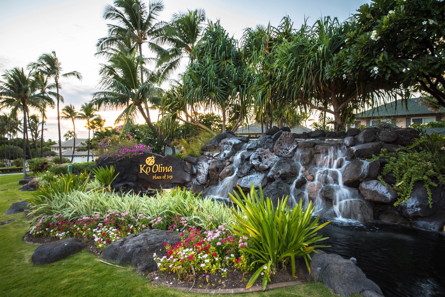 Kapolei Vacation Rentals, Ko Olina Beach Villas B210 - Tropical waterfall feature surrounded by palms and flowers.