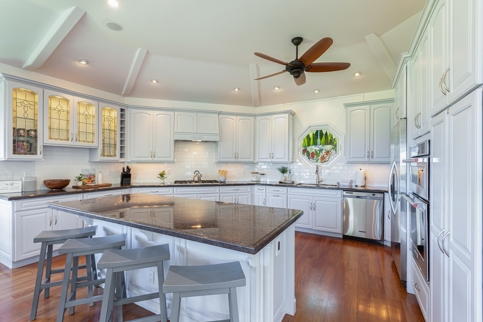 Princeville Vacation Rentals, Ohana Kamalani - Spacious and well-lit kitchen equipped with stainless steel appliances, perfect for hosting and gathering.