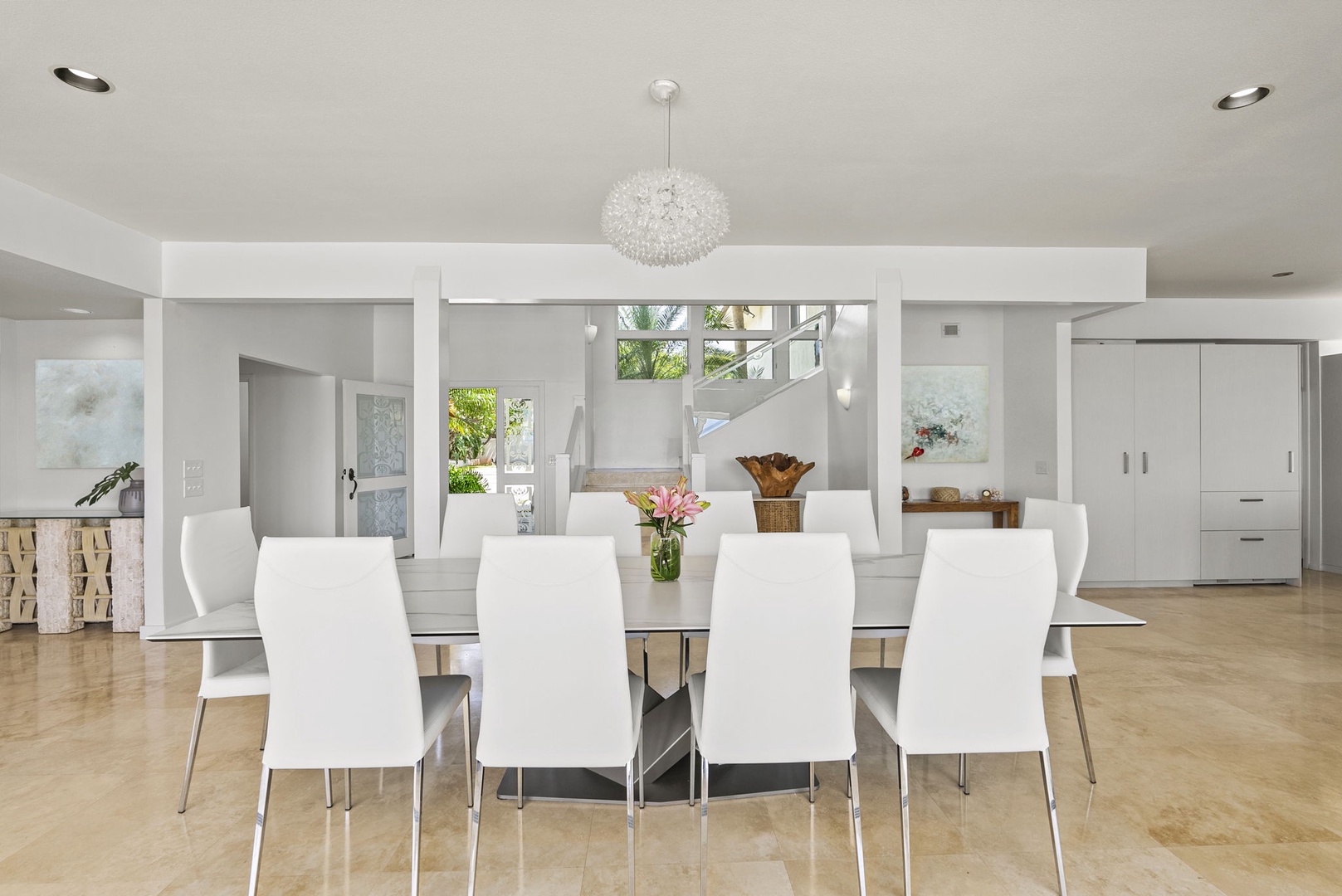 Honolulu Vacation Rentals, Paradise Beach Estate - Gather around a sleek, modern dining table beneath crystal lighting—perfect for elegant meals and memorable conversations.