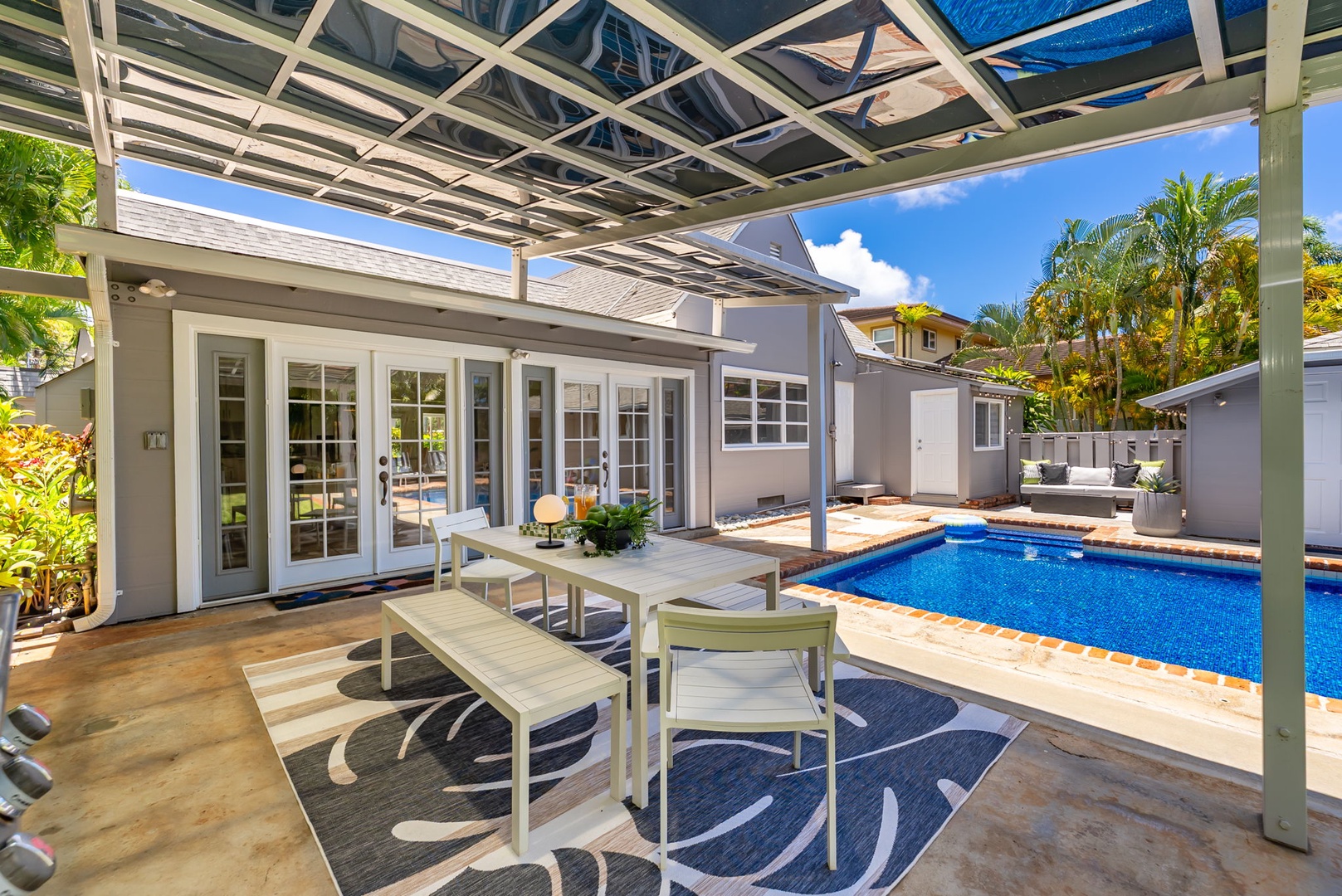 Honolulu Vacation Rentals, Ho'okipa Villa - Dine under your private pergola with sparkling pool views, lush palms, and sunny skies—your perfect backdrop for morning coffee or evening cocktails.