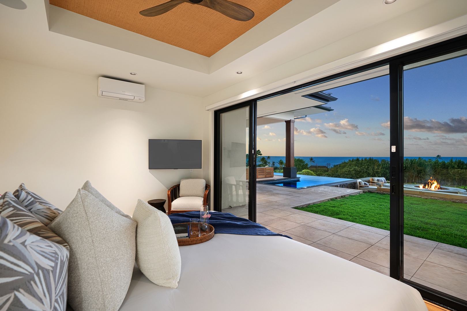 Koloa Vacation Rentals, Ke Kai Nui at Kukuiula - Bright and airy primary bedroom with sliding doors that open to lush views and private outdoor access.