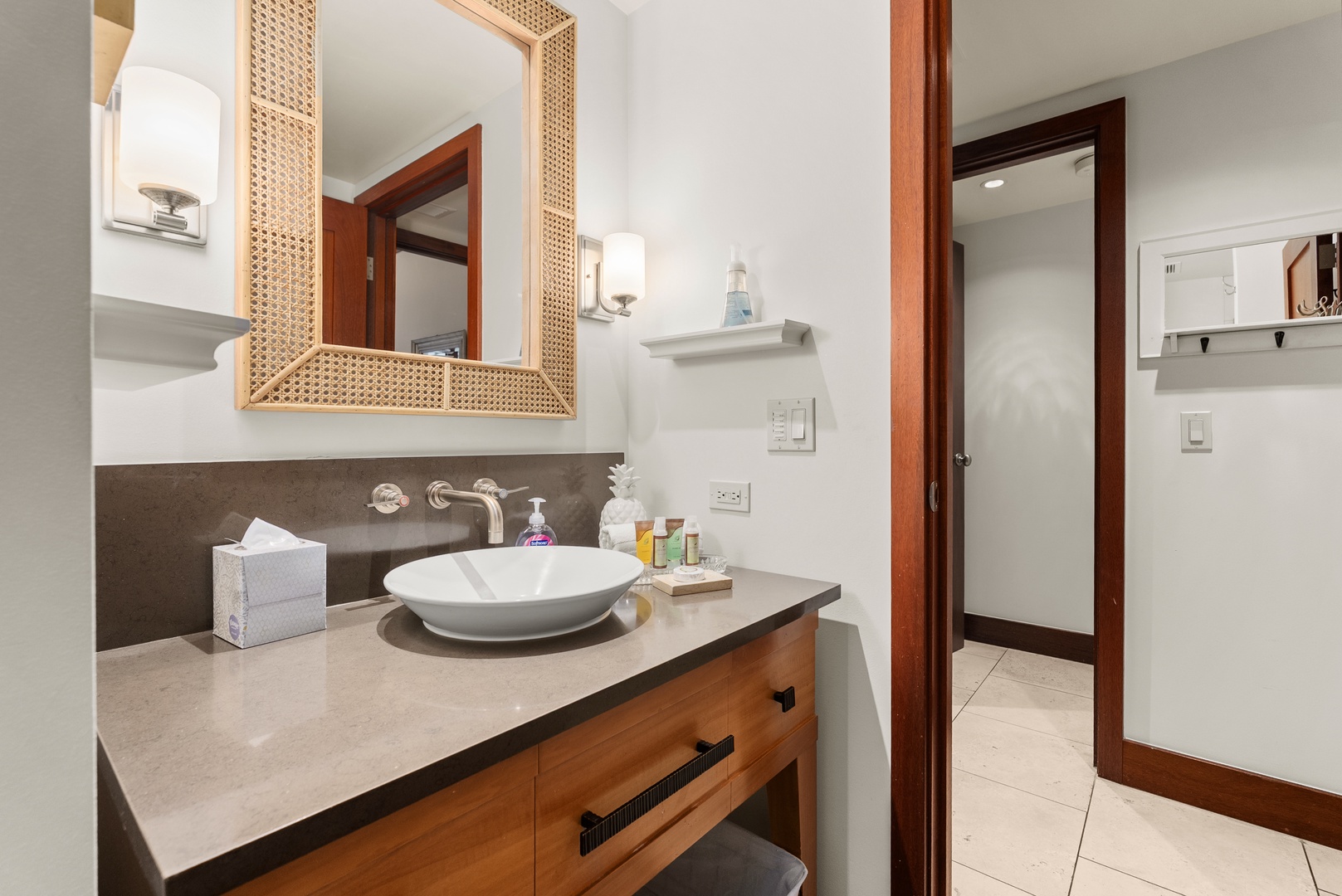 The guest bath provides plenty of room so nobody negotiates for the mirror before you head out.