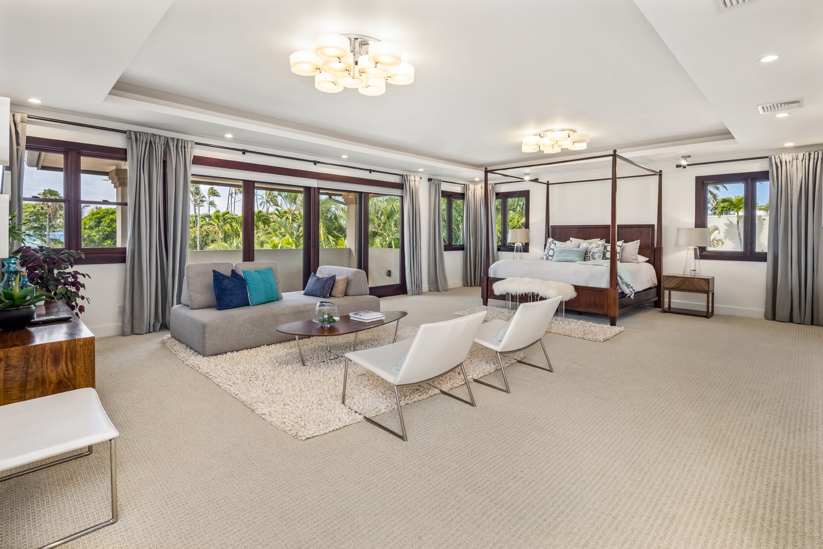 Honolulu Vacation Rentals, Kahala Grand Splendor - The primary suite offers a cozy sitting area with wall-to-wall windows and lush garden views.