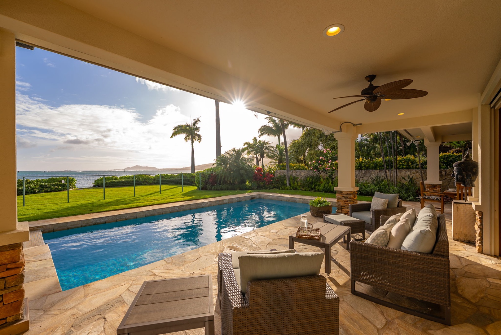 Honolulu Vacation Rentals, Maunalua Estate - Covered outdoor living spaces invite sunset conversations beside the pool and oceanfront lawn.