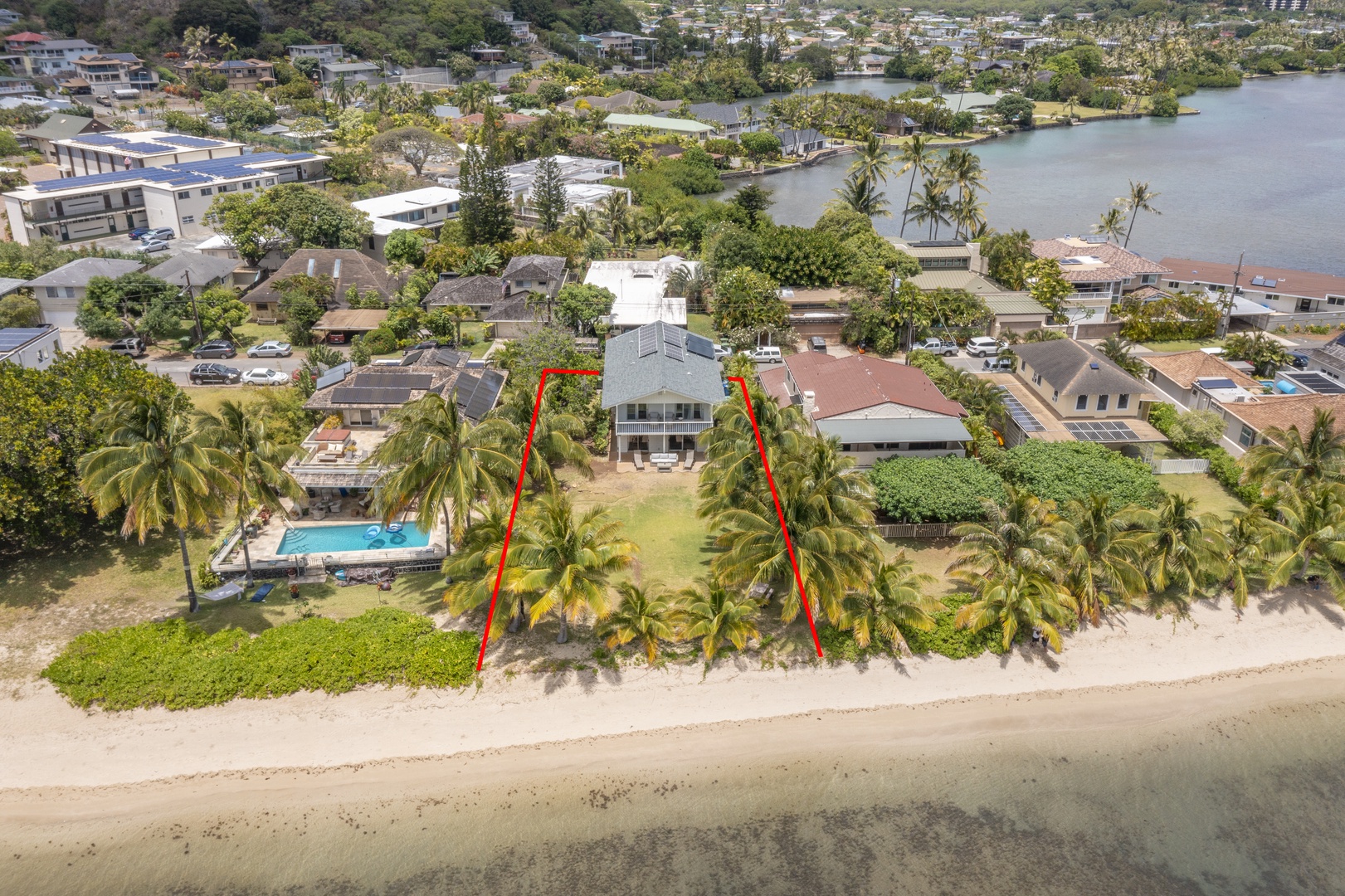 Honolulu Vacation Rentals, Honolulu Beachfront Retreat - Full aerial view of the home, emphasizing its beachfront proximity and spacious lot.